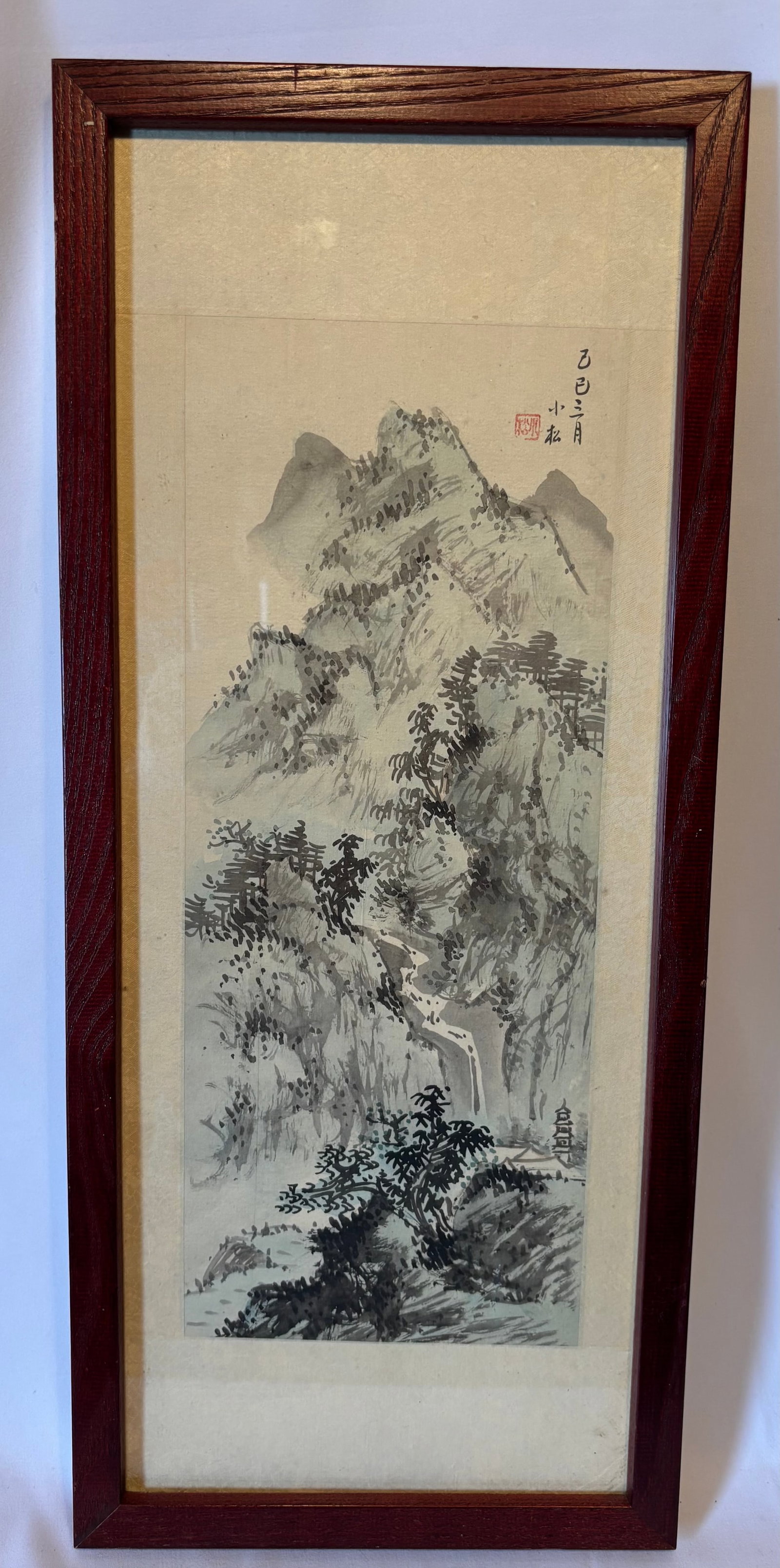 A Chinese Ink Landscape Painting, Signed Xiaosong, Dated Jisi Year: Chinese ink and wash landscape painting depicting a mountainous scene with trees and rocky outcroppings. Inscribed “Jisi Year, Third Month” and signed Xiaosong with artist seal. Framed under g