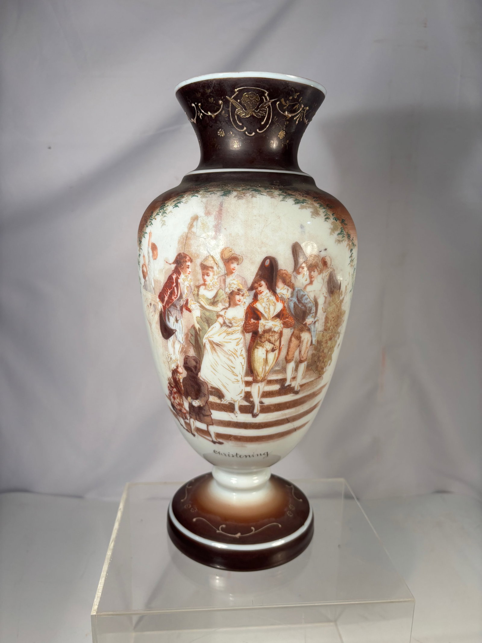 A European Hand Painted Porcelain Vase, “Christening?? Scene, Late 19th / Early 20th Century: European hand painted porcelain vase decorated with a sepia-toned “Christening” scene depicting figures in period attire gathered on architectural steps. The composition is finely rendered in 