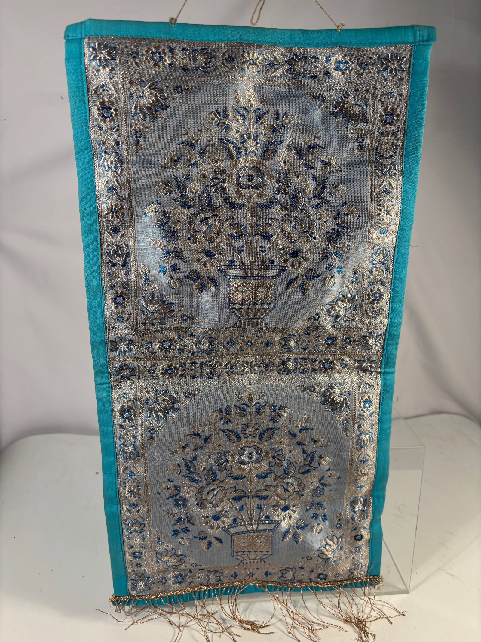 Persian Silk Embroidered Textile pannel with Floral Vase Motif: Persian embroidered silk textile runner featuring a central floral bouquet in a vase surrounded by a decorative floral border. Likely mid 20th century. Dimensions: 20 x 10 inches.