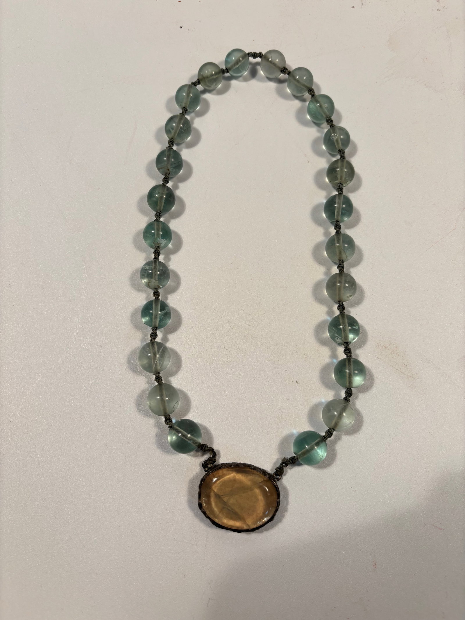 A transparent green color hard stone necklace with silver clasp: A spherical translucent beads with a faint greenish-blue hue and subtle internal zoning — characteristics that strongly suggest fluorite or other hard stone. Dimensions?beads size : 12.3mm, total
