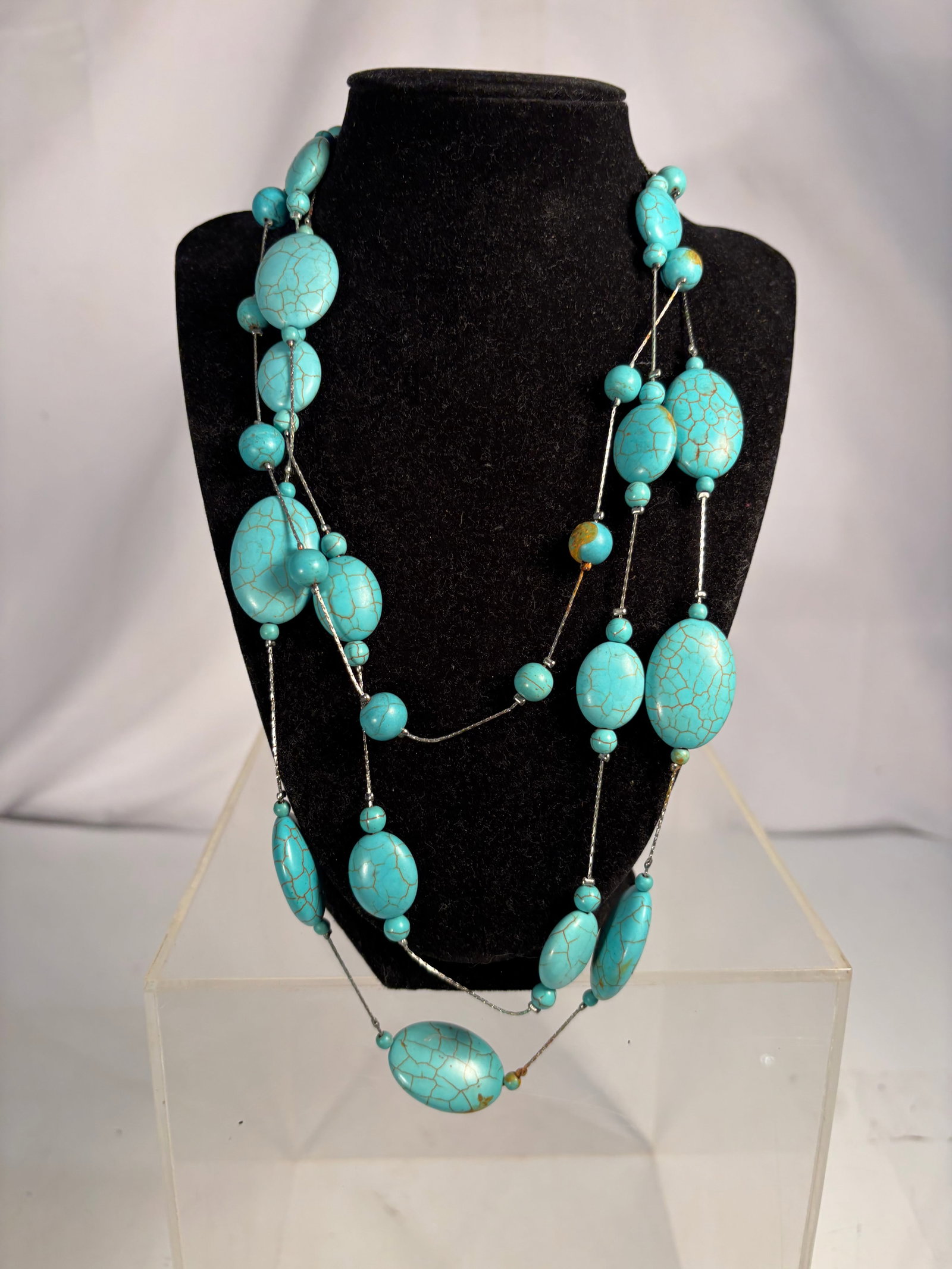 Three-Strand Turquoise Bead Necklace with Silver-Tone Chain, 21 Inches: Three-strand necklace featuring turquoise beads in graduated oval and round forms connected by silver-tone chain links. The layered design creates an elegant, dimensional look. Measures approximately 