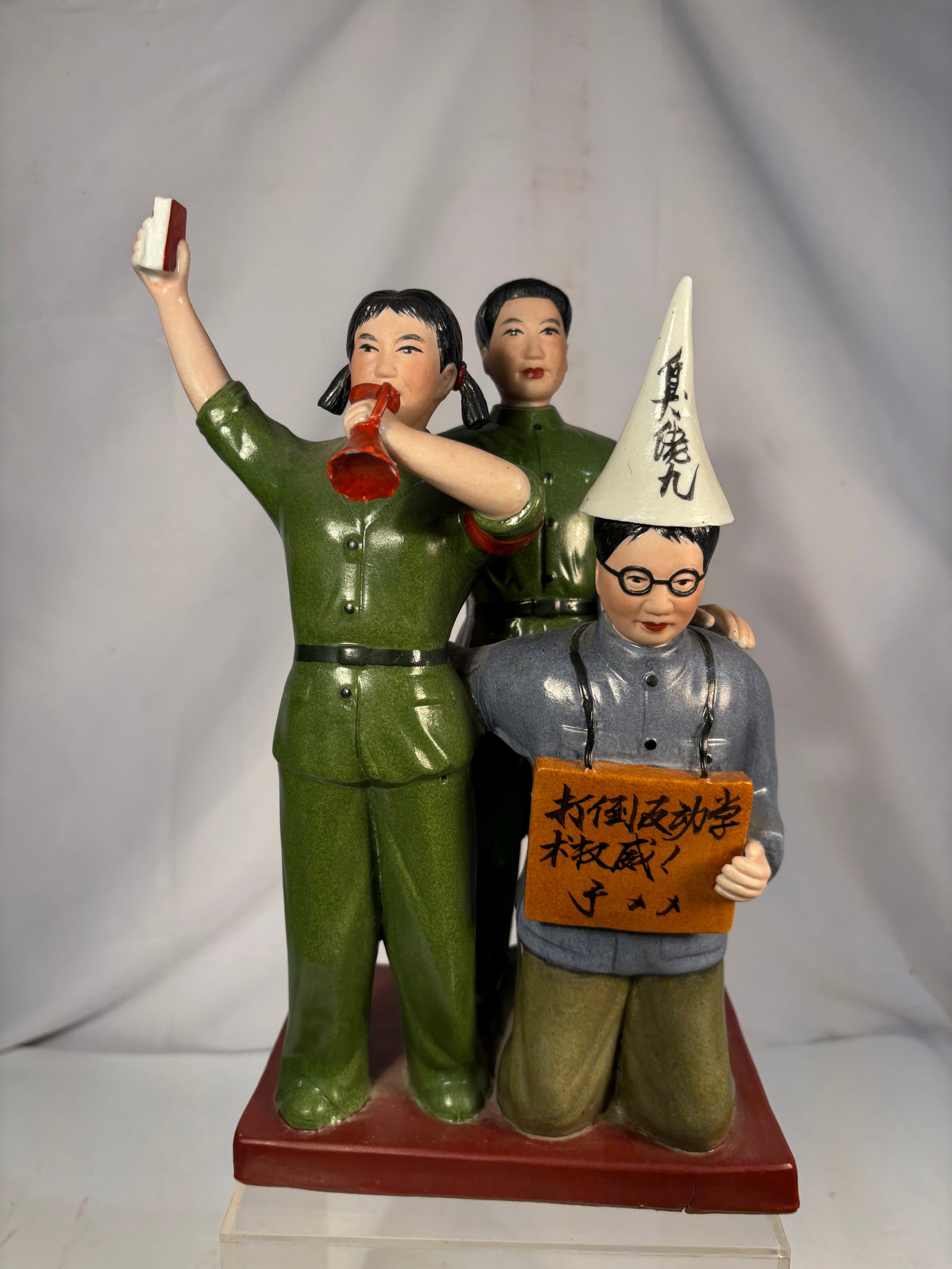 Chinese Cultural Revolution-Style Ceramic Red Guard “Struggle Session?? Figural Group: A Chinese polychrome ceramic figural group depicting two Red Guards conducting a Cultural Revolution-style “struggle session” against a kneeling intellectual wearing glasses, a pointed denunci