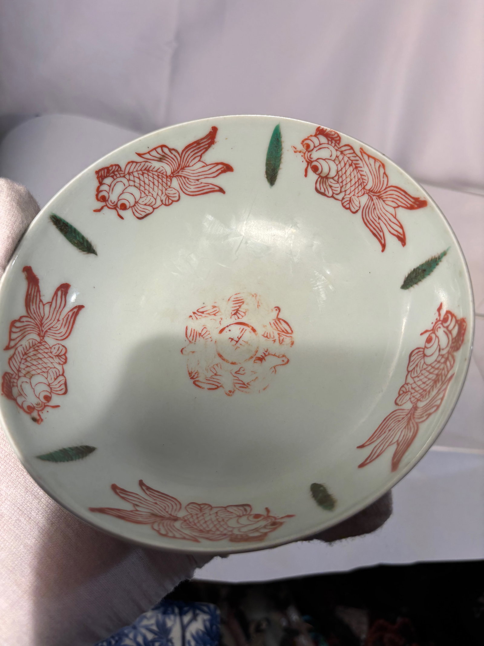 A Chinese Famille-Verte Porcelain Bowl with Iron-Red Fish: Qing dynasty(1644-1912); Probably kangxi period ; Delicately potted with gently flared sides rising from a short circular foot, the bowl is finely decorated in iron-red and translucent green enamels. 