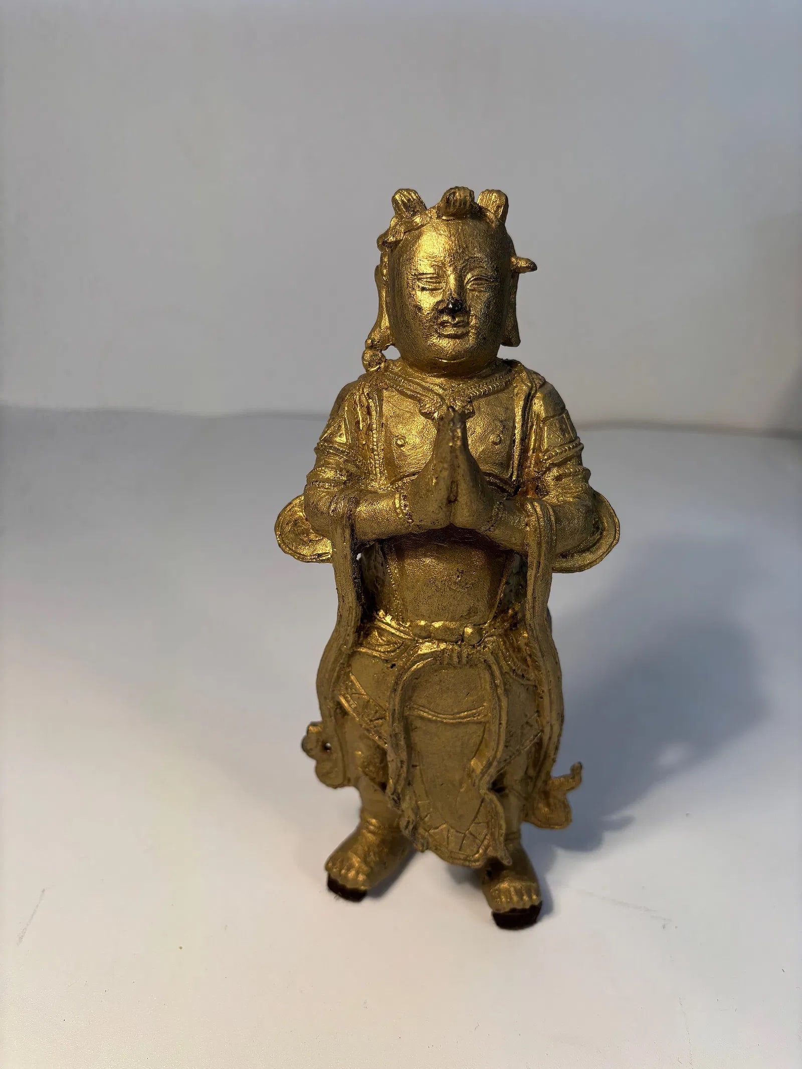 A Chinese gilt bronze standing figure statue: Ming Dynasty (1368-1644), This is a gilt bronze Buddhist figure, likely from China or Tibet, depicting a deity or bodhisattva in a prayer posture (anjali mudra). From an old Northshore Chicago family 