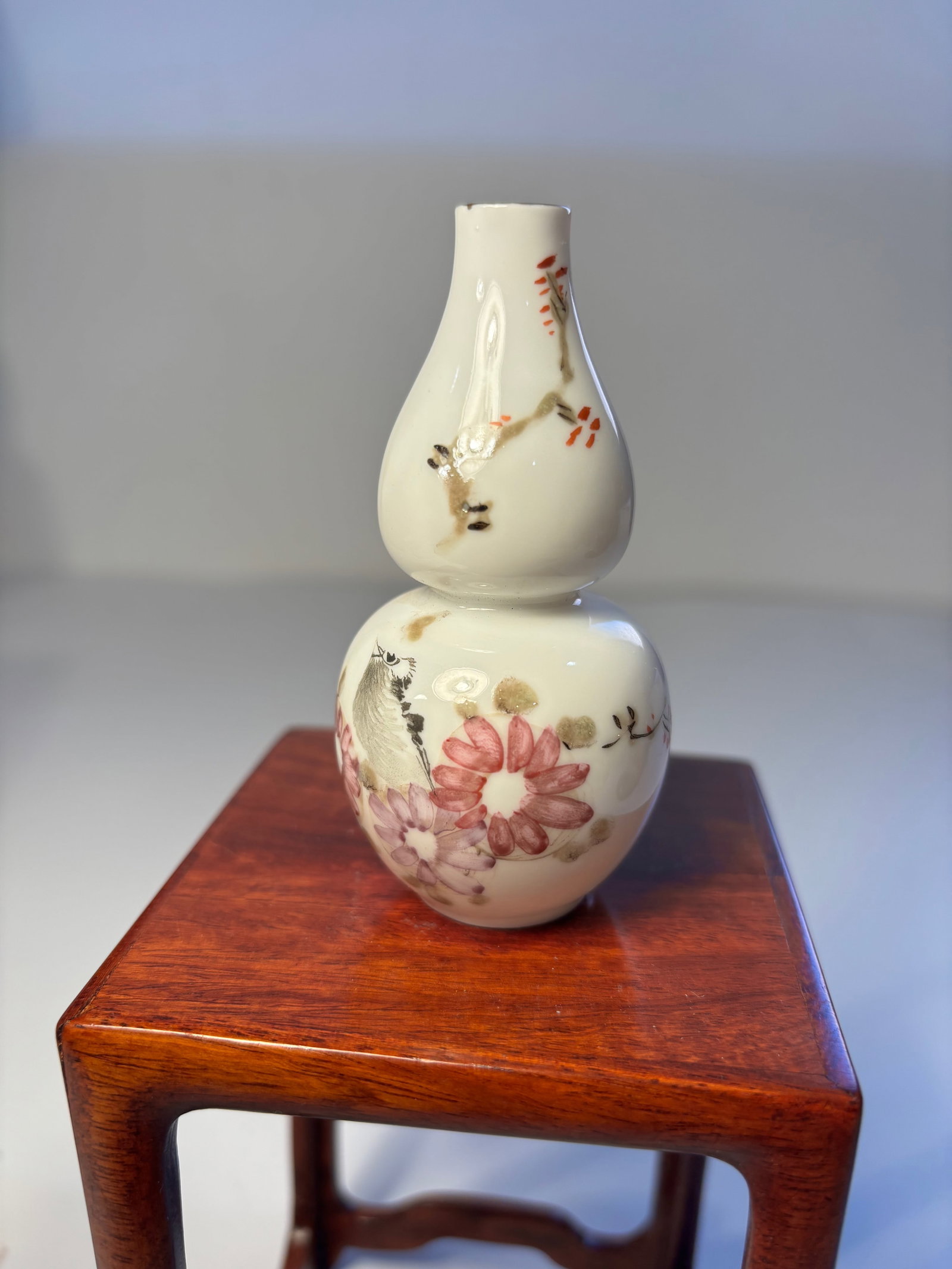 A Chinese egg shell famille rose porcelain gourd vase: Early 20th century; Eggshell porcelain is incredibly thin, sometimes only a few millimeters thick. The delicate floral painting, likely depicting cherry blossoms or similar flowers, is in line with tr