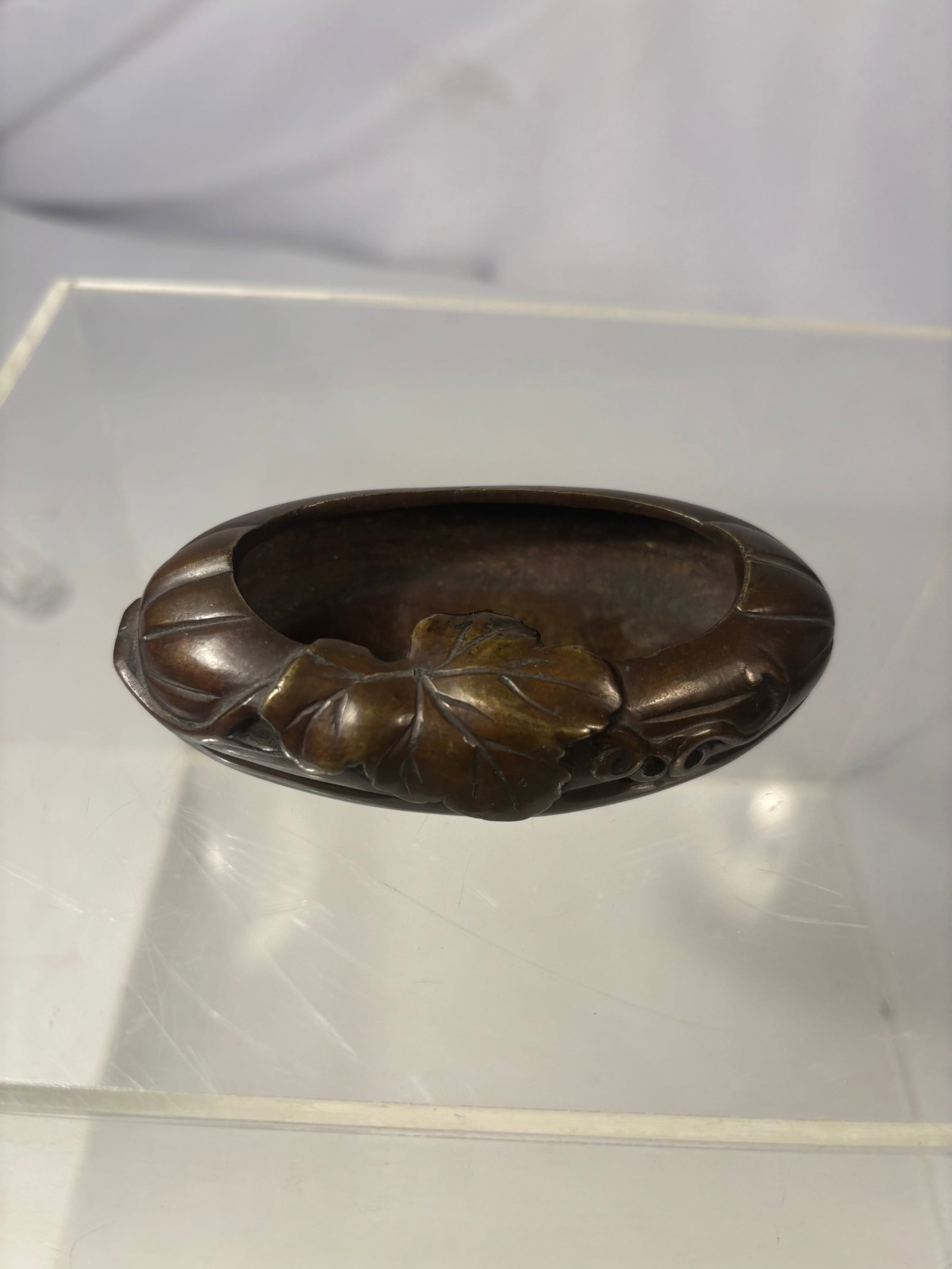 Japanese Meiji-Period Bronze Floral Brush Washer / Water Pot, Meiji Period (1868–1912),: A Japanese cast-bronze oval water pot or brush washer, decorated in high relief with overlapping leaves, blossoms, vines, and seed-pod motifs. The vessel has a deep recessed basin and a warm brown pat