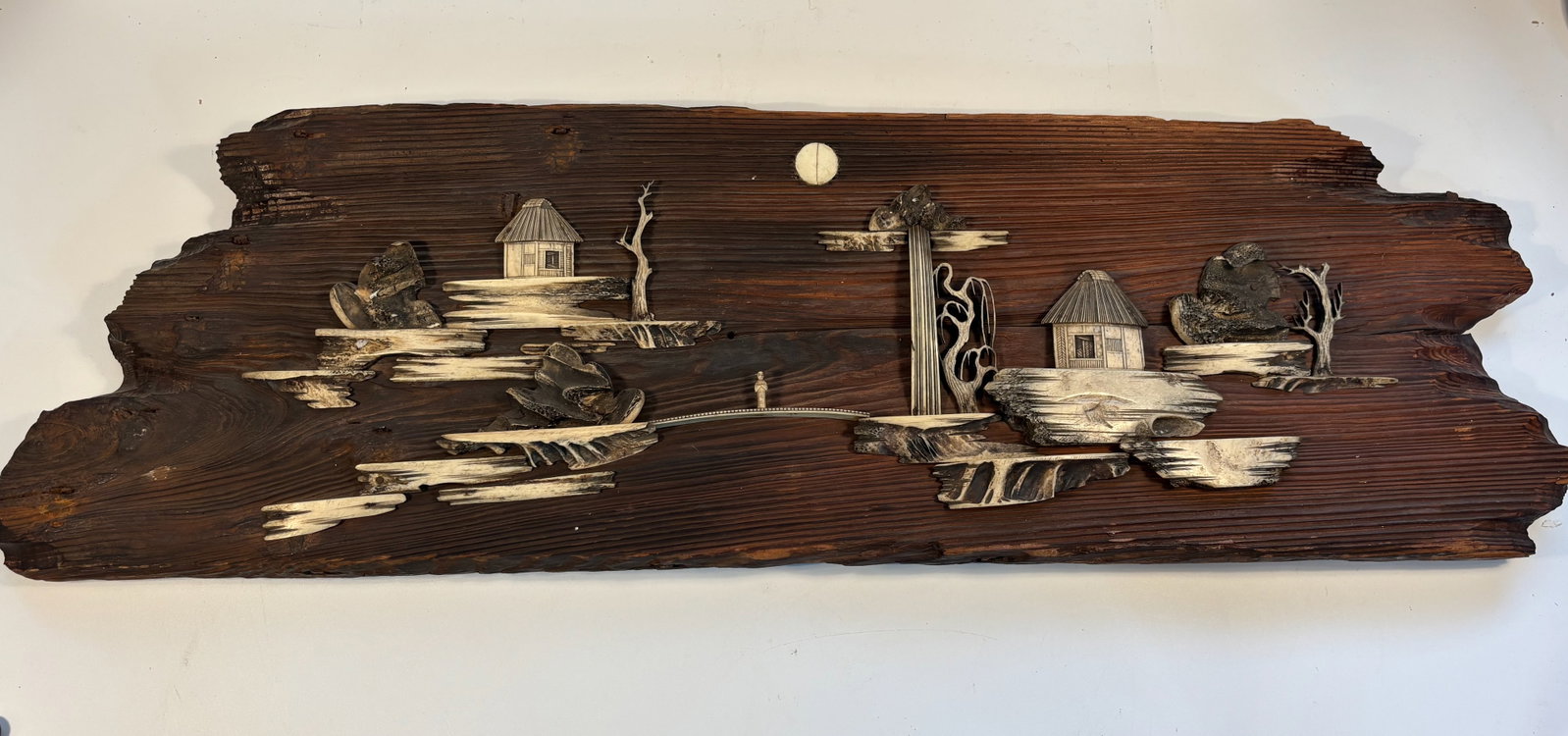 A Large Vintage bone carved scene on Driftwood
