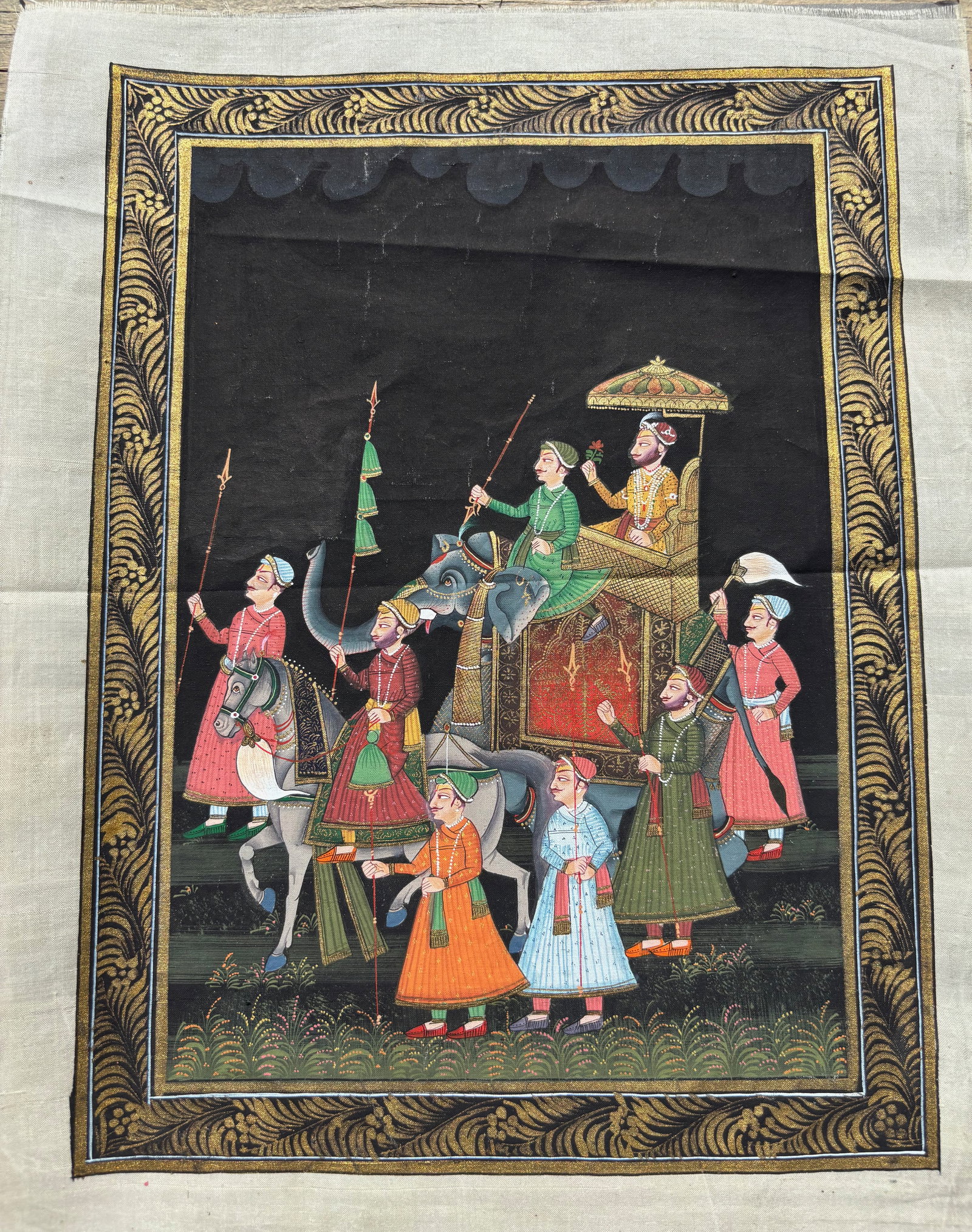 Hand-Painted Indian Miniature on Silk – Mughal Royal Procession with Elephant and Horseback: 19th century; A finely executed Indian miniature painting on silk, depicting a regal Mughal procession. The central figure is a nobleman or emperor seated in a lavish howdah atop a caparisoned elephan