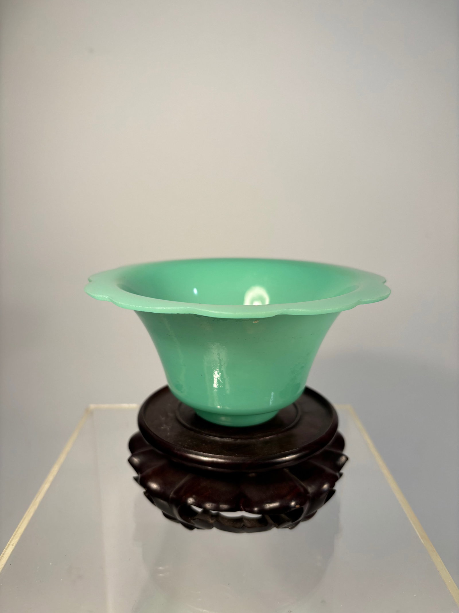 A Chinese Peking Glass Bowl – Jadeite Green, carved "MADE IN CHINA": Qing Dynasty(1644-1912); A graceful Chinese Peking glass bowl in an elegant lobed form, molded from opaque jadeite-green glass with a soft, glossy surface. The form mimics that of a stylized melon or 