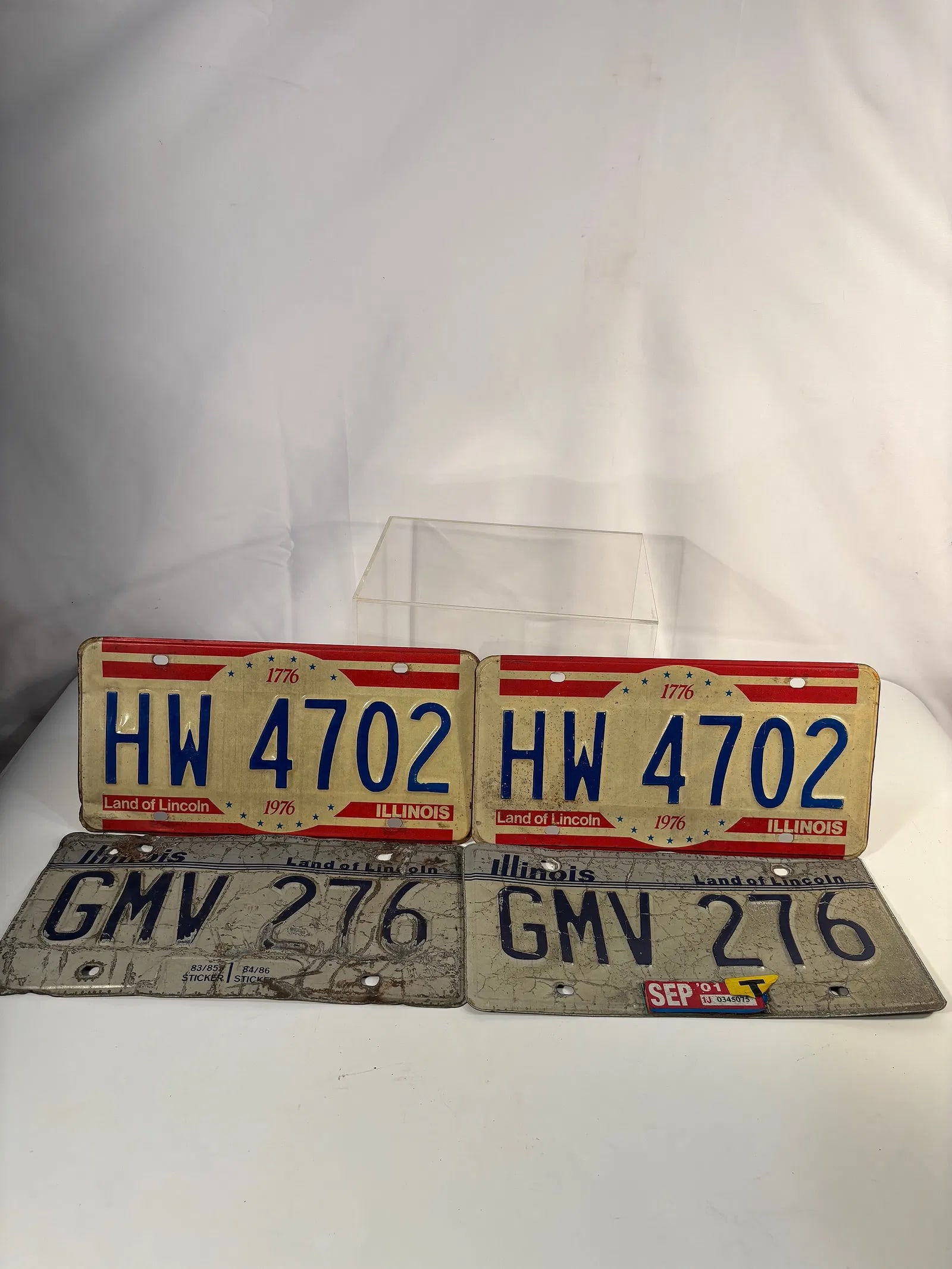 Pair of 1976 Illinois Bicentennial License Plates & Pair of 1981 Illinois Plates – Land of Lincoln: A lot of two pairs (four total) vintage Illinois automobile license plates.The first pair commemorates the U.S. Bicentennial, 1776–1976, with patriotic red, white, and blue graphics and “Land of L