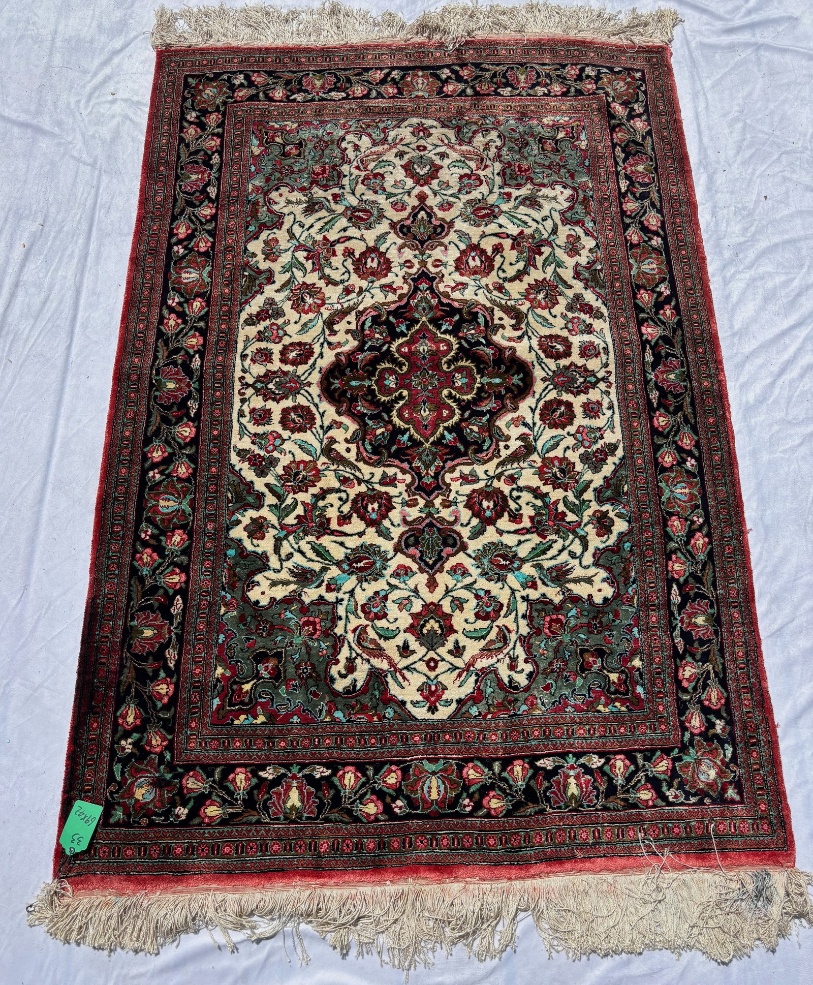 Vintage Heriz-Style Silk Rug , 69 x 42 in.: Featuring an ivory field centered by an intricate geometric floral medallion amidst stylized scrolling vines and floral motifs within multiple decorative borders. Executed in tones of ivory, navy, bur