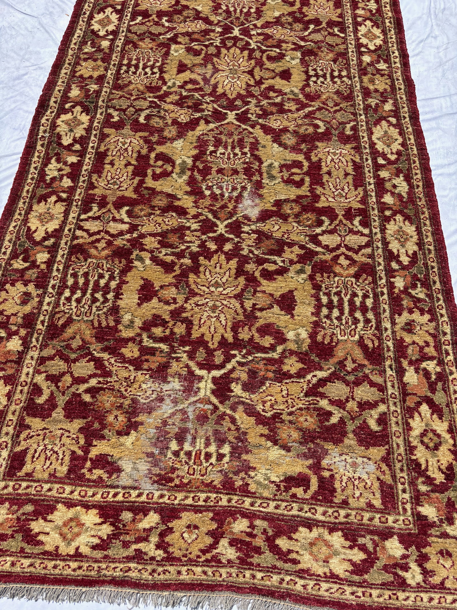 Vintage Indo-Persian Agra-Style Wool Rug, 110 x 49 in.: Featuring an allover lattice and stylized palmette design on a rich burgundy field with scrolling vine and floral motifs within multiple decorative borders. Executed in burgundy, gold, ivory, and mute
