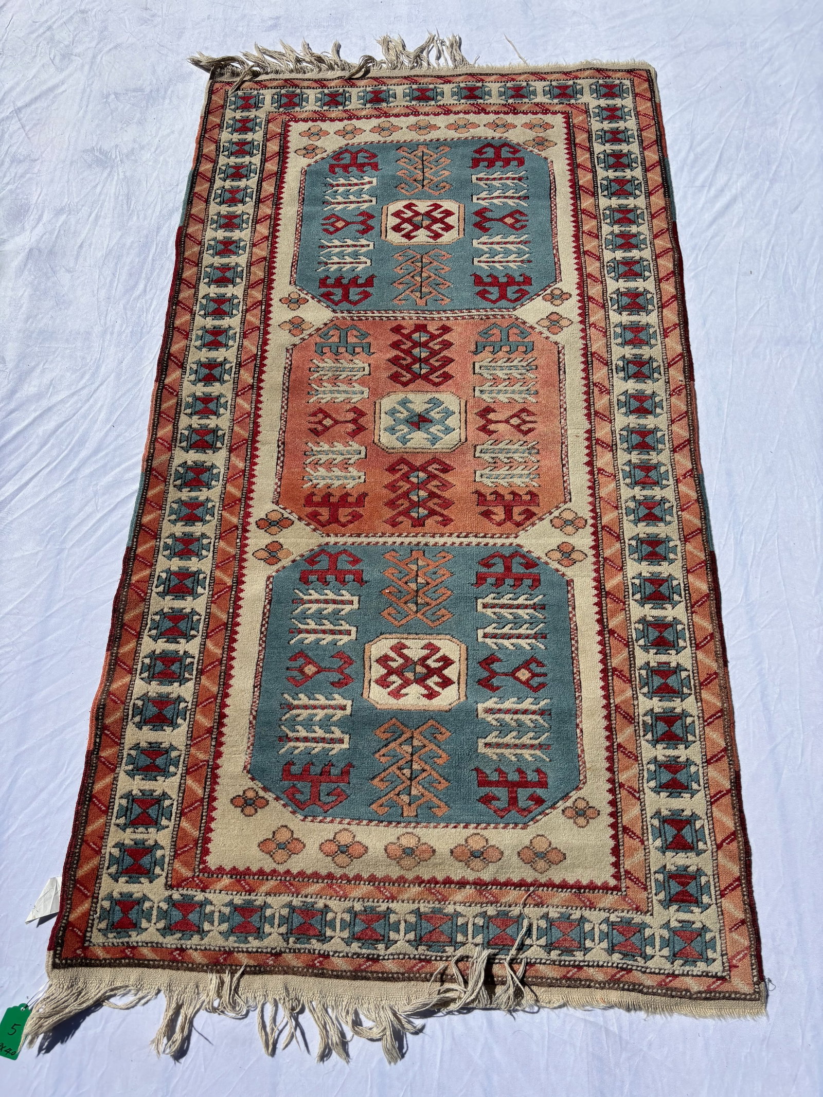 Fine Hand Knotted Caucasian Kazak Style Wool Rug, 79 x 40 in.: A finely hand knotted Caucasian Kazak style wool rug featuring bold geometric medallions and stylized tribal motifs in sky blue, ivory, coral, and red tones. Exhibiting detailed border work, balanced 