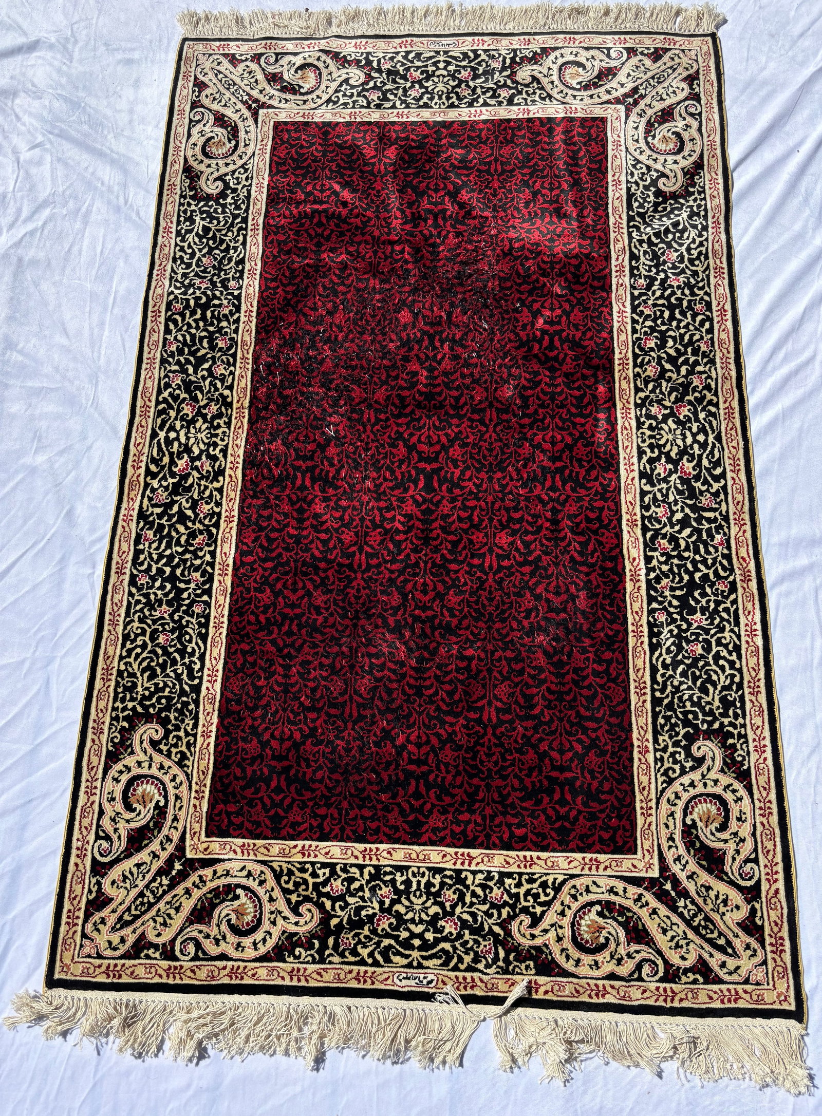 Contemporary Nepalese Silk Carpet with Crimson and Black Scrollwork 66 x 37 inches.: A finely hand knotted Nepalese silk rug featuring an intricate scrolling vine design in rich crimson and black tones with contrasting decorative borders. Exhibiting exceptional luminous silk sheen and