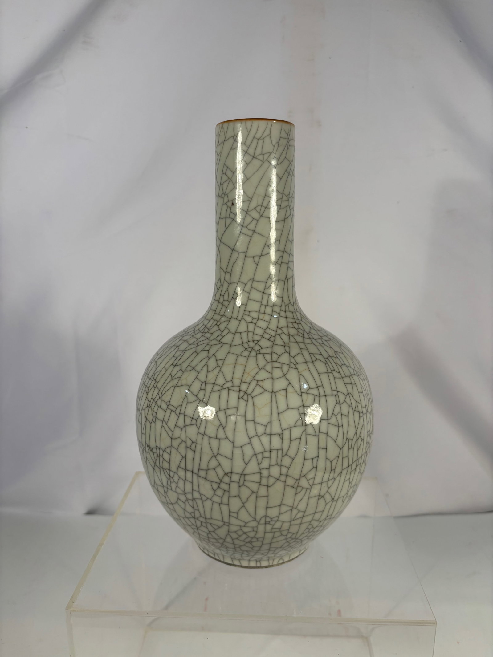 A Chinese Ge-Type Crackle-Glazed Celadon Vase , Qianlong period: 18th century , Ge-type crackle-glazed celadon vase of bottle form, with a rounded globular body rising to a tall cylindrical neck. The vase is covered overall in a pale gray-green glaze with a dense