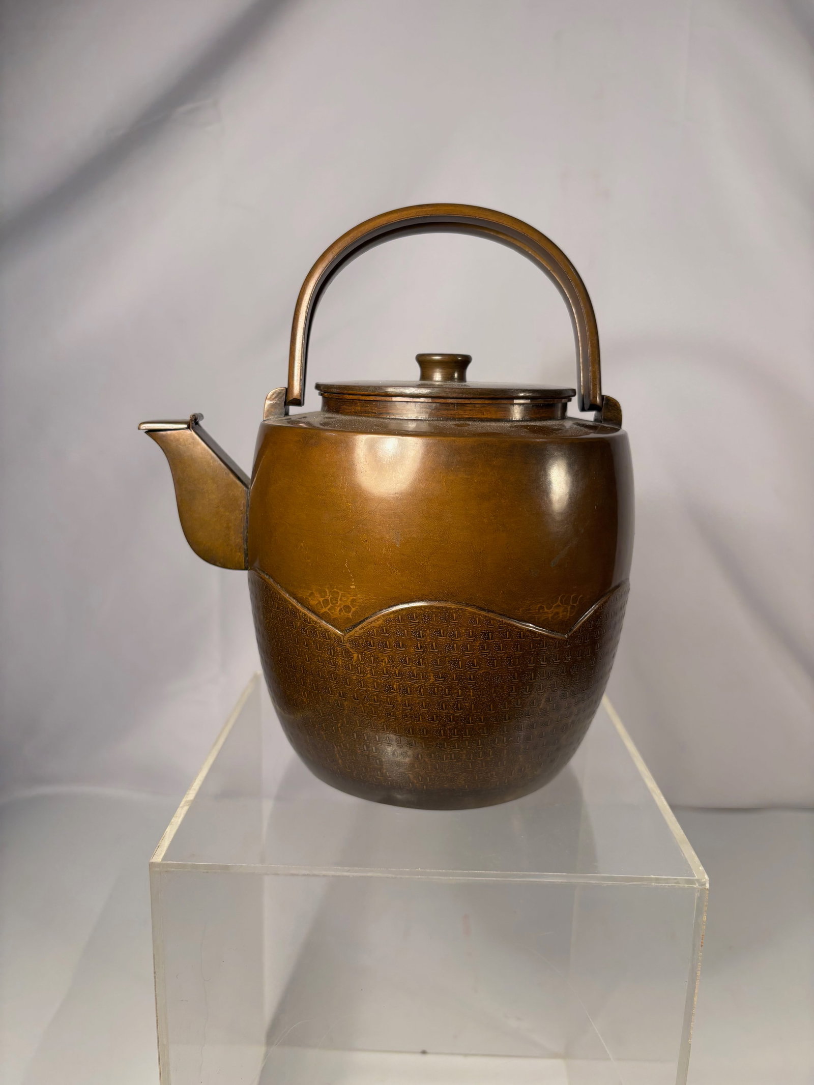 A Japanese Signed Metal Teapot (Yakan) with Wooden Storage Box (Edo–Meiji Period , 1850-1900): A Japanese metal teapot (yakan), likely dating to the late Edo to Meiji period. The vessel features a rounded body with an integrated spout and a fixed arched handle, showing a warm brown patina
