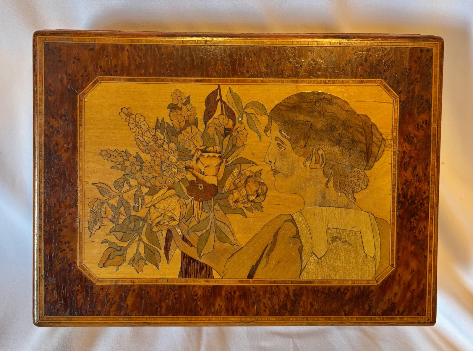 French Art Nouveau Style Burlwood Veneer Ladies Box: Decorative wooden box featuring burlwood veneer panels and an inset image of a lady holding flowers in the Art Nouveau taste. Raised on rounded feet with fitted hinged lid. Likely early to mid 20th ce