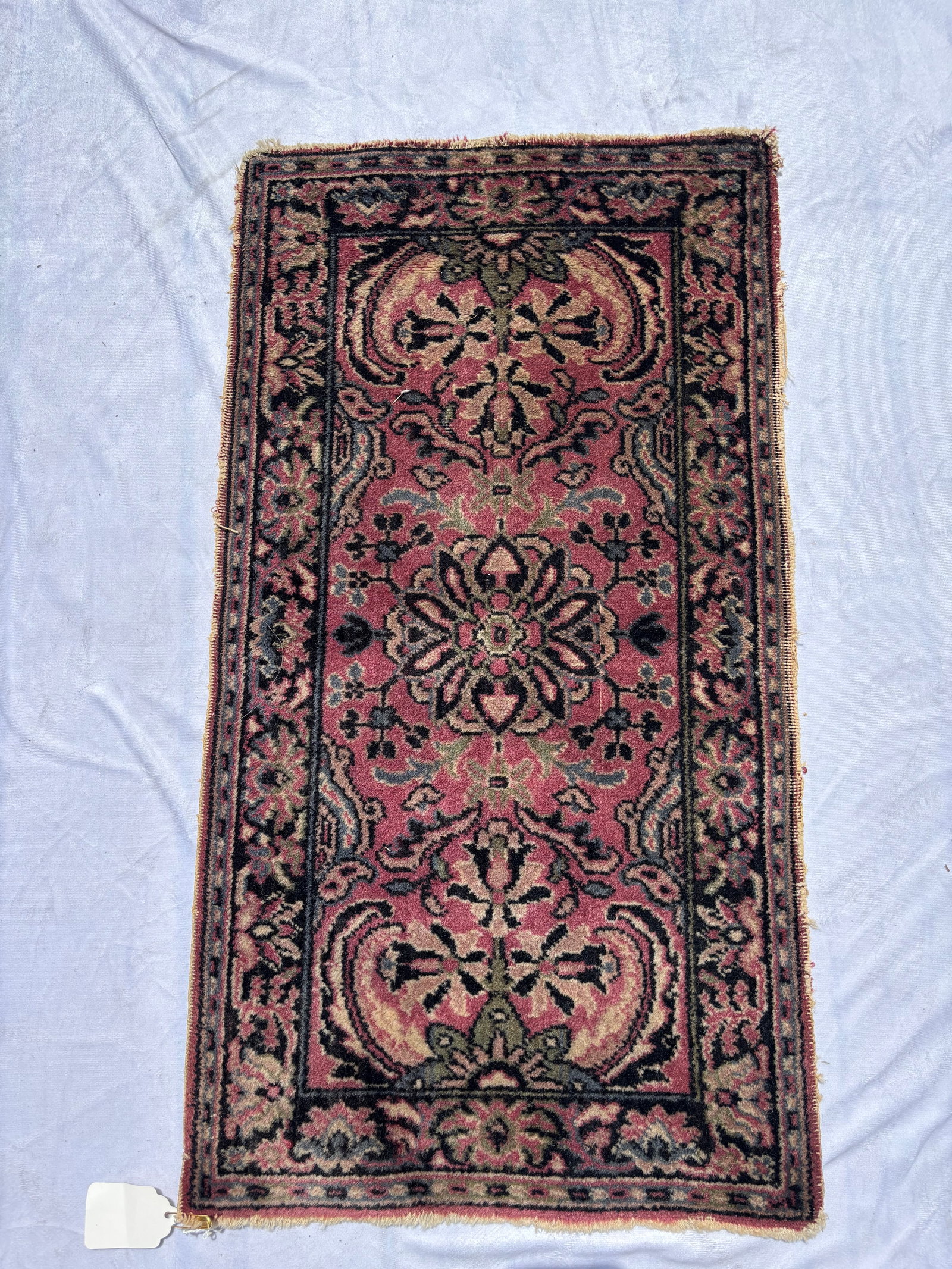 Antique Hand-Knotted Persian Sarouk Style Rug, 25 x 18 Inches: Hand-knotted wool rug featuring a floral design on a rose-pink field with decorative borders. Persian Sarouk/Lilihan style. Measures approximately 25 x 18 inches. Inventory #51.