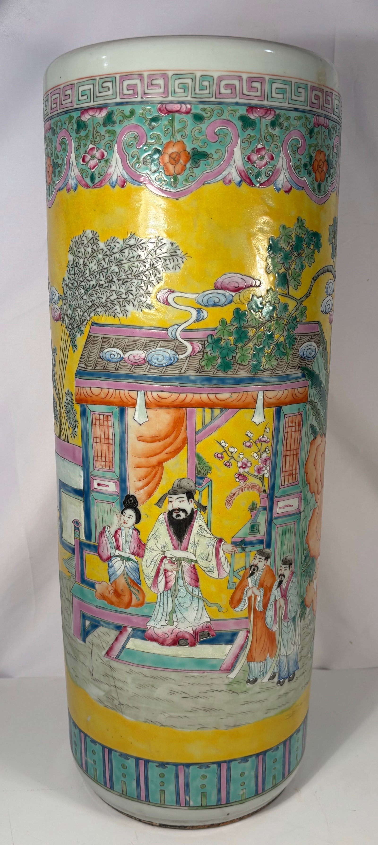 A Chinese Famille Rose Yellow-Ground Figural Porcelain Vase: 19th century; This tall Chinese porcelain vase is decorated in the famille rose palette on a rich yellow ground, finely painted with a continuous figural court scene depicting scholars and attendants 