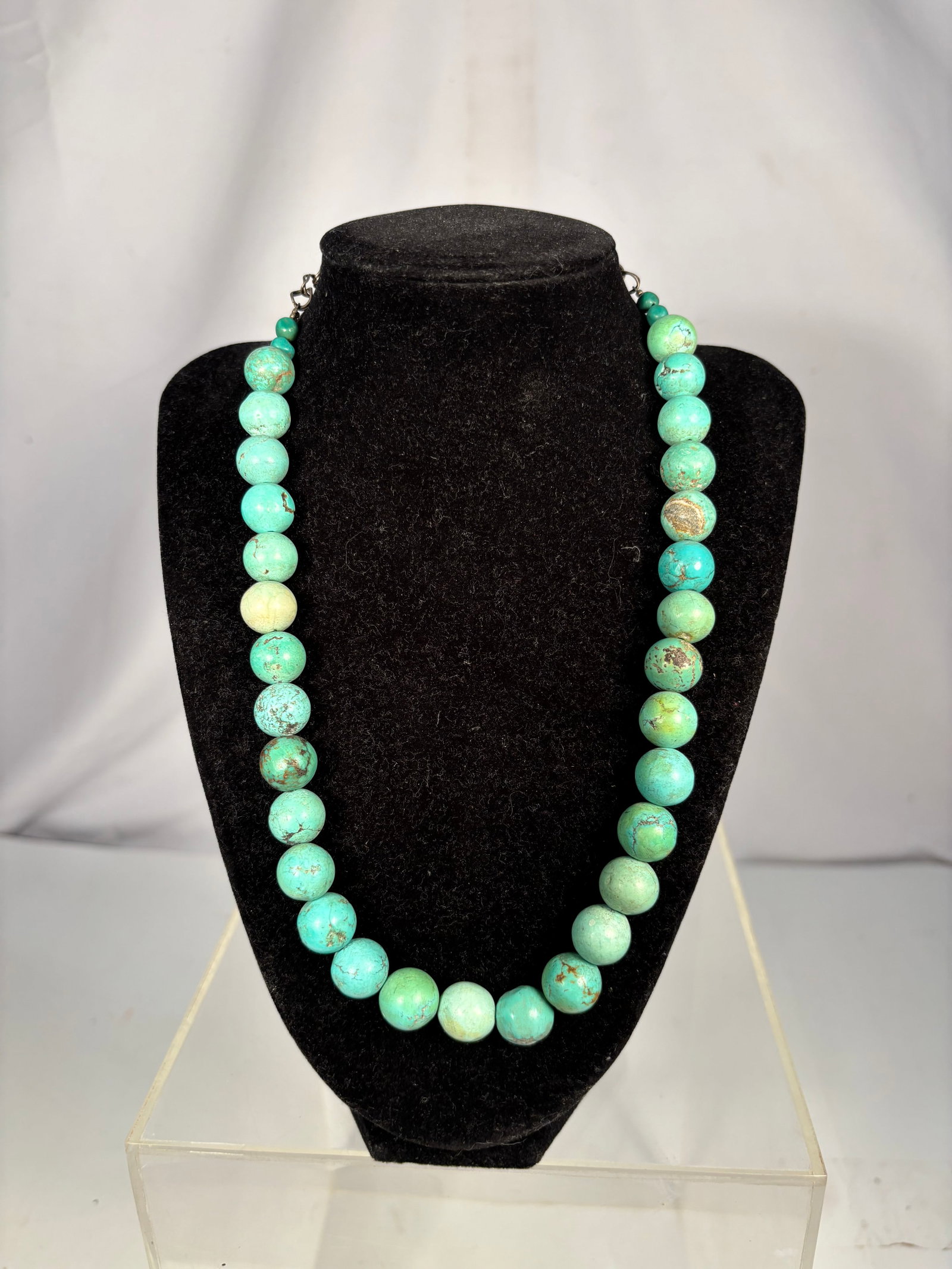 Vintage Turquoise Stone Bead Necklace, 75.08 Grams: A vintage single-strand necklace composed of turquoise round stone beads displaying natural-looking brown matrix and color variations. The larger beads measure approximately 13.6 mm. Finished with sma