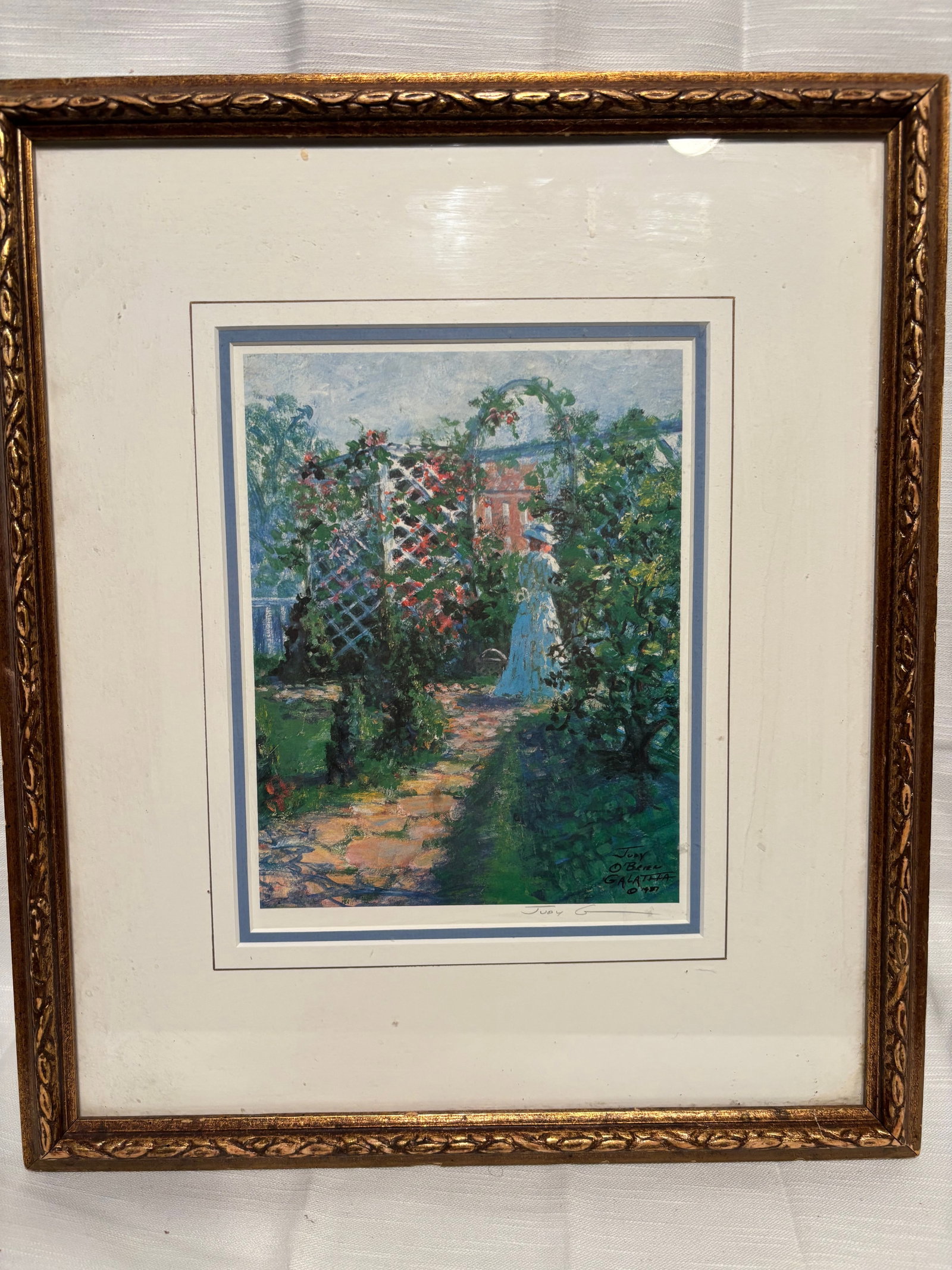 Judy O’Brien Galatha (American, North Carolina), Girl in the Garden Dated 1987: An original acrylic painting on gessoed Masonite by Judy O’Brien Galatha (Charlotte, North Carolina), titled Girl in the Garden. The composition depicts a serene female figure standing within a lush