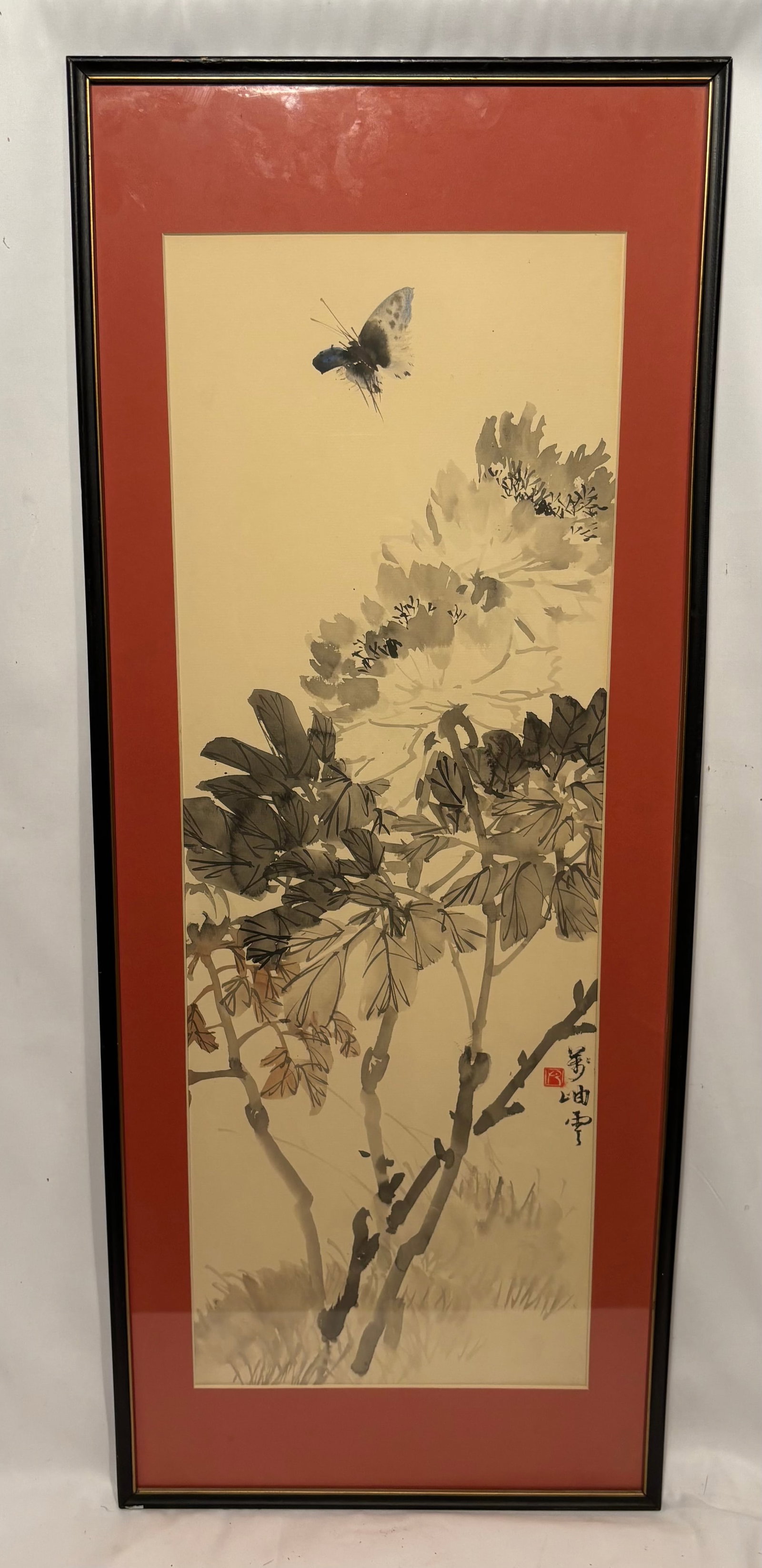 Chinese Ink and Color Painting of Butterfly and Blossoms, Signed: Chinese ink and color painting depicting a butterfly above flowering branches. Signed and bearing a red seal lower right. Presented in a frame with red matting under glass .Framce size: 36x 25 in.