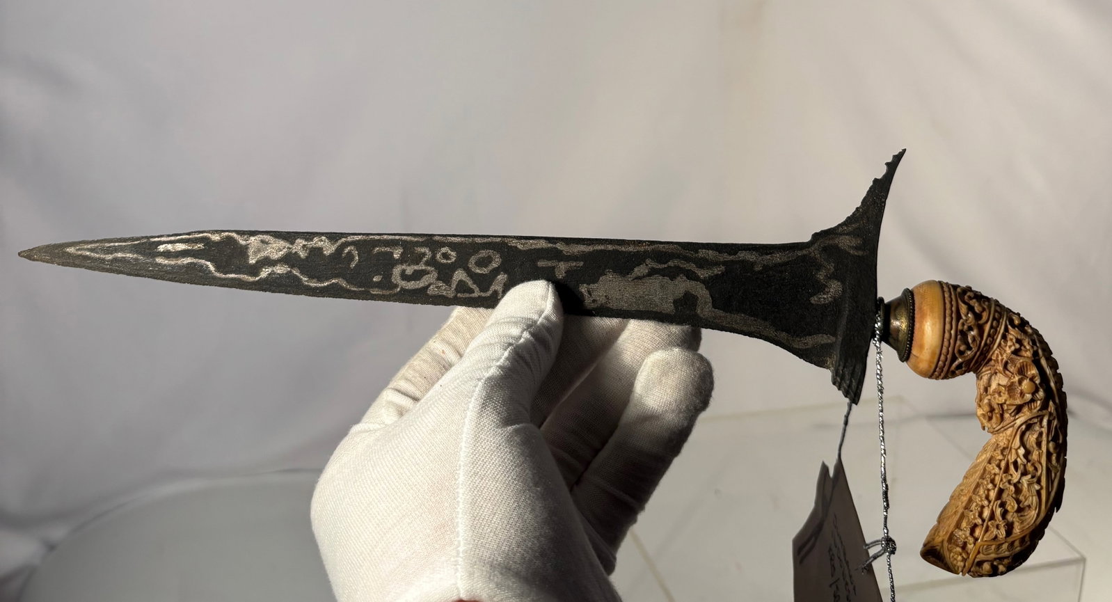 Sumbawa Indonesian Kris (Keris) Dagger with Pamor Blade and Carved Bone Hilt, Late 19th–Early 20th: An Indonesian kris (keris) dagger from Sumbawa, featuring a straight (lurus) pamor-forged blade with natural nickel–iron patterning. The blade exhibits traditional darkened patina with visible pamor