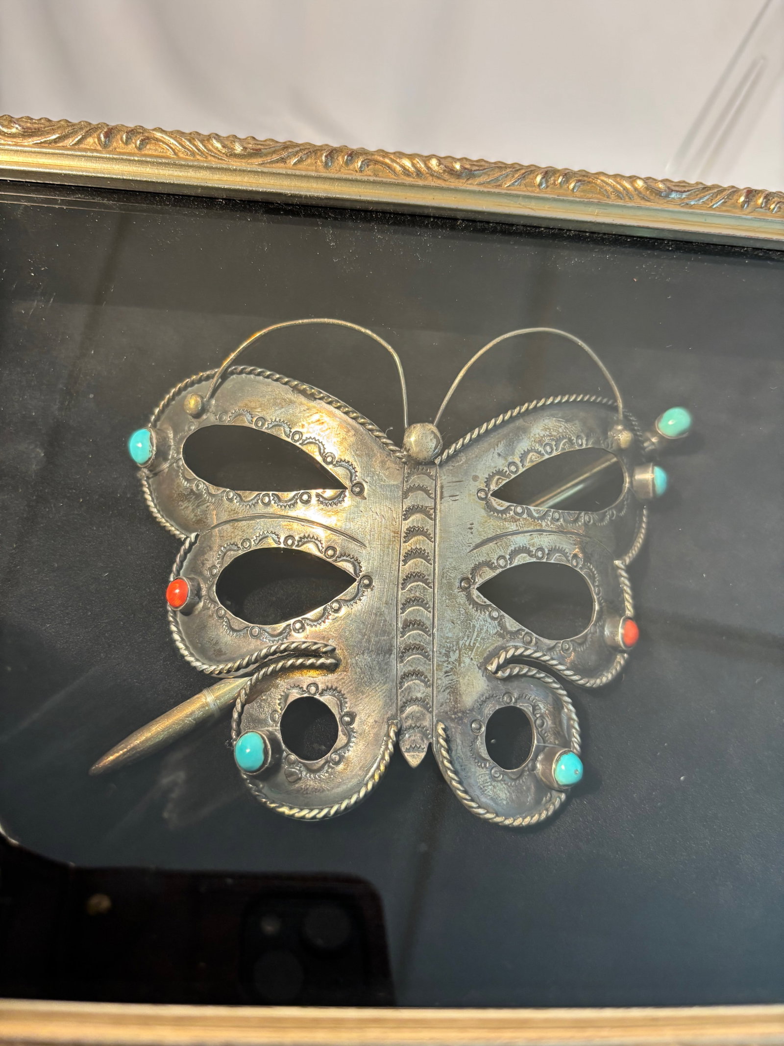 A Tibetan Silver Butterfly Ornament with Turquoise and Coral Inlay,: Qing Dynasty(1644-1912);Of openwork form, finely crafted as a butterfly with repoussé and wirework details, the wings set with turquoise and coral cabochons. Such ornaments were traditionally used as
