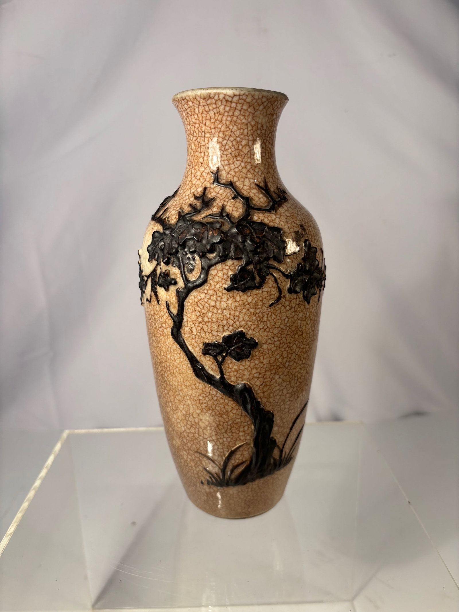 A Chinese Ge- type Crackle-Glazed Porcelain Vase: Qing dynasty(1644-1912) ; A Chinese vase decorated with a finely crackled cream-to-caramel glaze, the surface covered with an even network of Ge-type crackle lines. Around the shoulder and upper body 