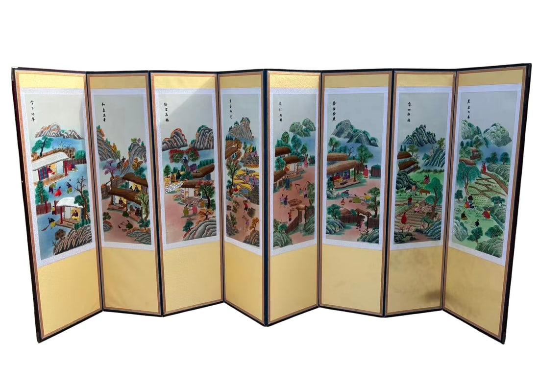 A Korean Style Embroidered Eight-Panel Folding Screen, Rural Village Scene: A decorative eight-panel folding screen featuring finely embroidered scenes of rural village life, including agricultural activities, figures, and landscape elements rendered in vibrant colors.The