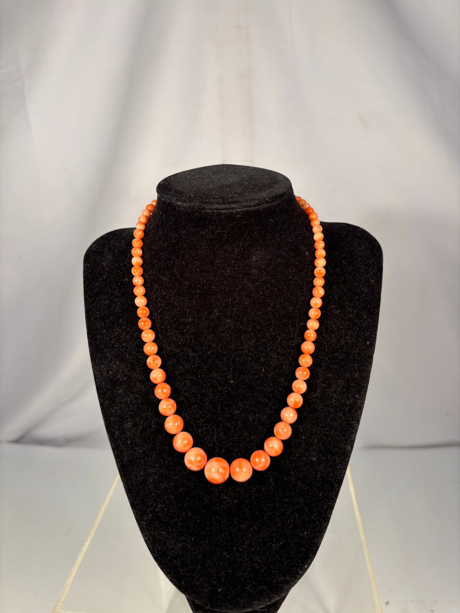 Vintage Graduated Peach Coral Bead Necklace, 17 in., 12 mm Largest Bead, 28.2 g: Vintage graduated necklace featuring polished peach to salmon-colored round beads, graduating from approximately 5 mm to 12 mm. Measures approximately 17 inches in length and weighs 28.2 grams. Finish