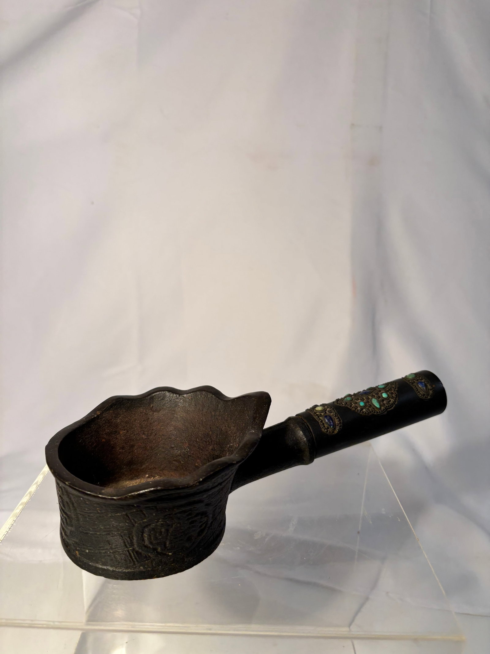 A Chinese Metal Charcoal Iron with Turquoise and Lapis Inlaid Handle: Qing Dynasty(1644-1912); A Chinese metal charcoal iron , featuring a rounded bowl with scalloped rim and a long handle decorated with applied metalwork and inset stones, including turquoise and lapis-