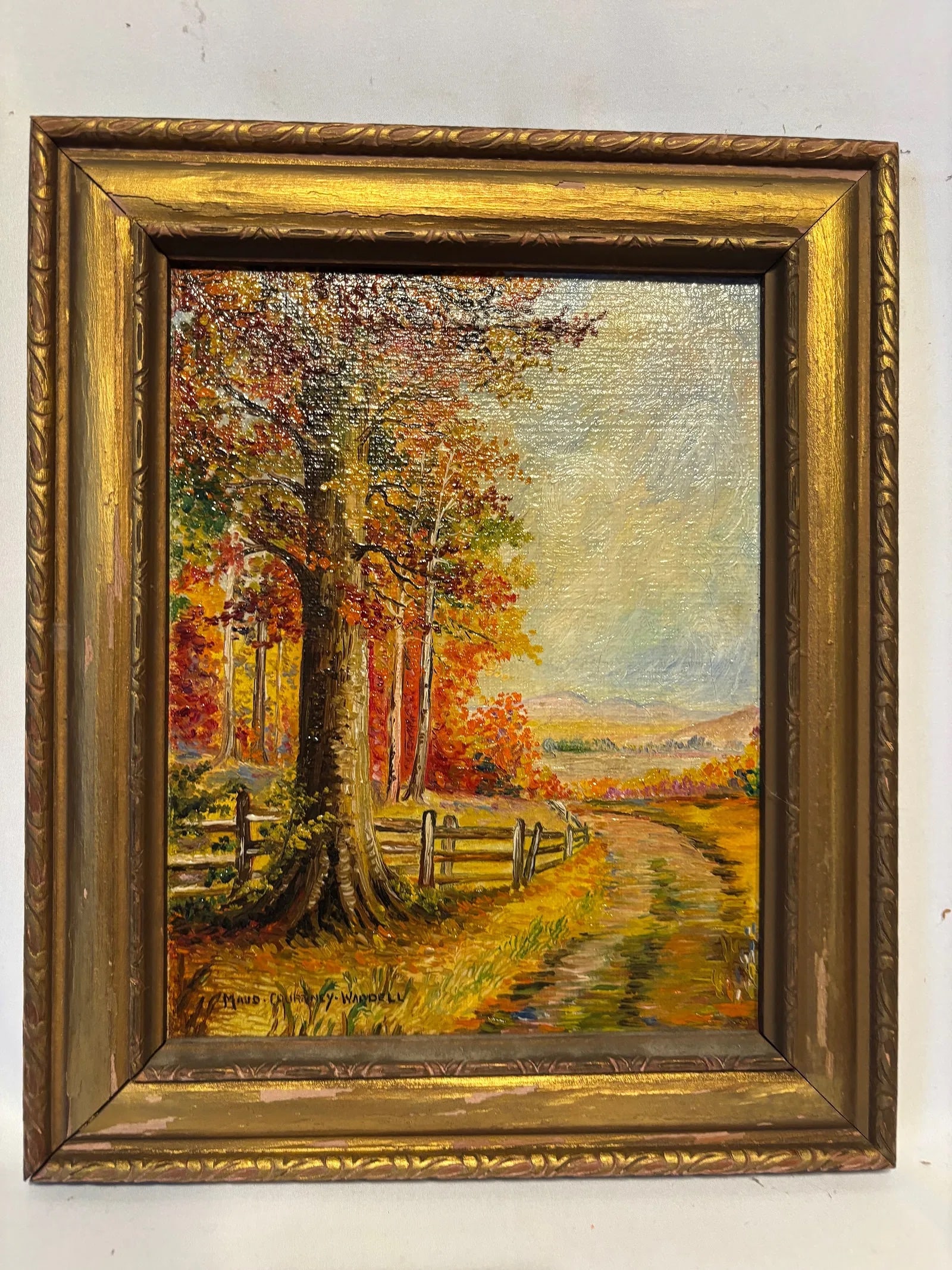 Maud Courtney Waddell Autumn Landscape Oil on Canvas: Signed lower left “Maud Courtney Waddell.” Oil on canvas depicting a colorful autumn landscape with towering trees, rustic split-rail fencing, and a winding country road leading toward distant
