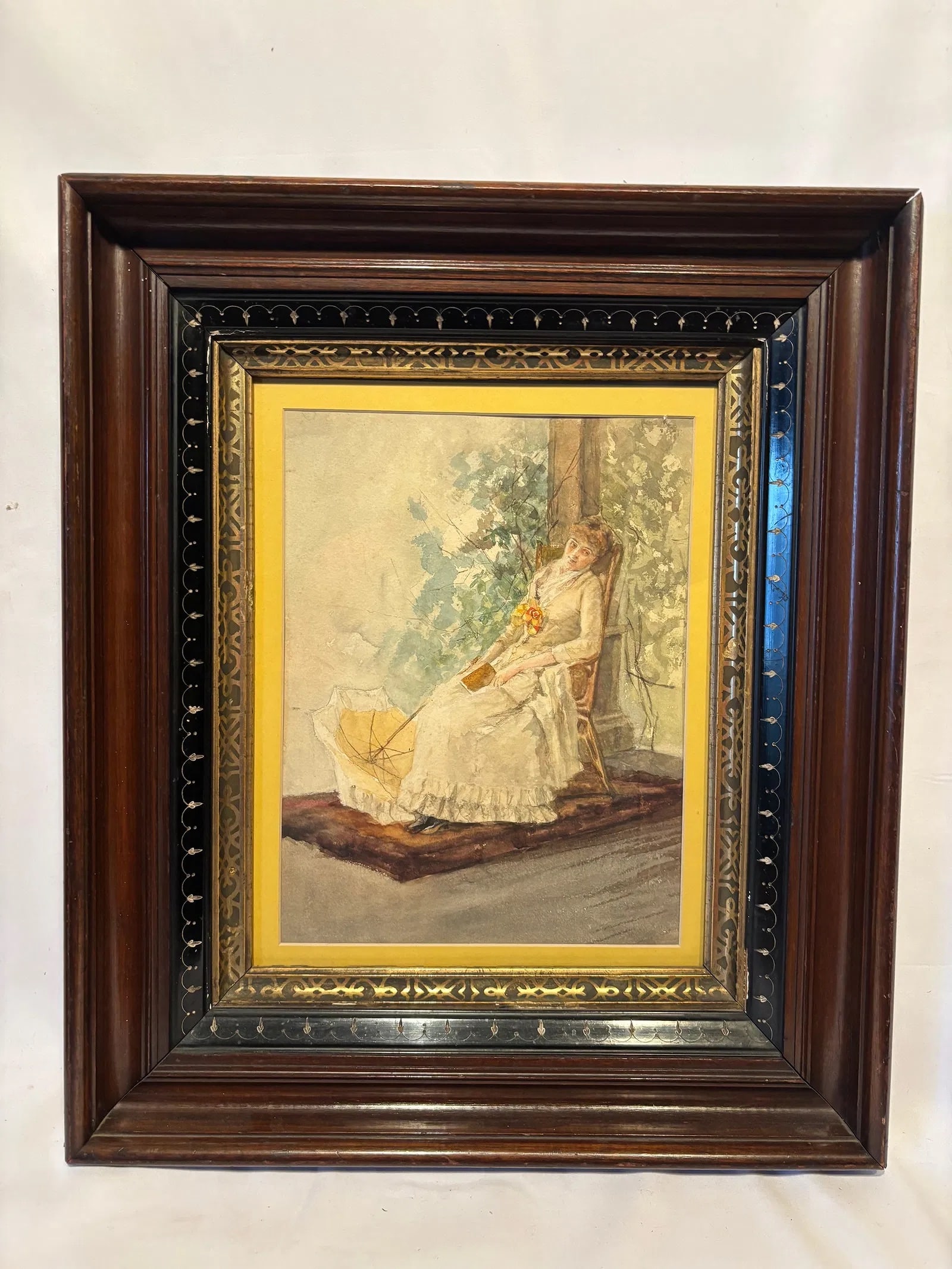 Victorian Style Young Lady with Parasol Watercolor Painting: Watercolor painting depicting a seated young woman holding a book beside a garden column, with a parasol resting at her side. Executed in a delicate palette with soft pastel tones and romantic Victori