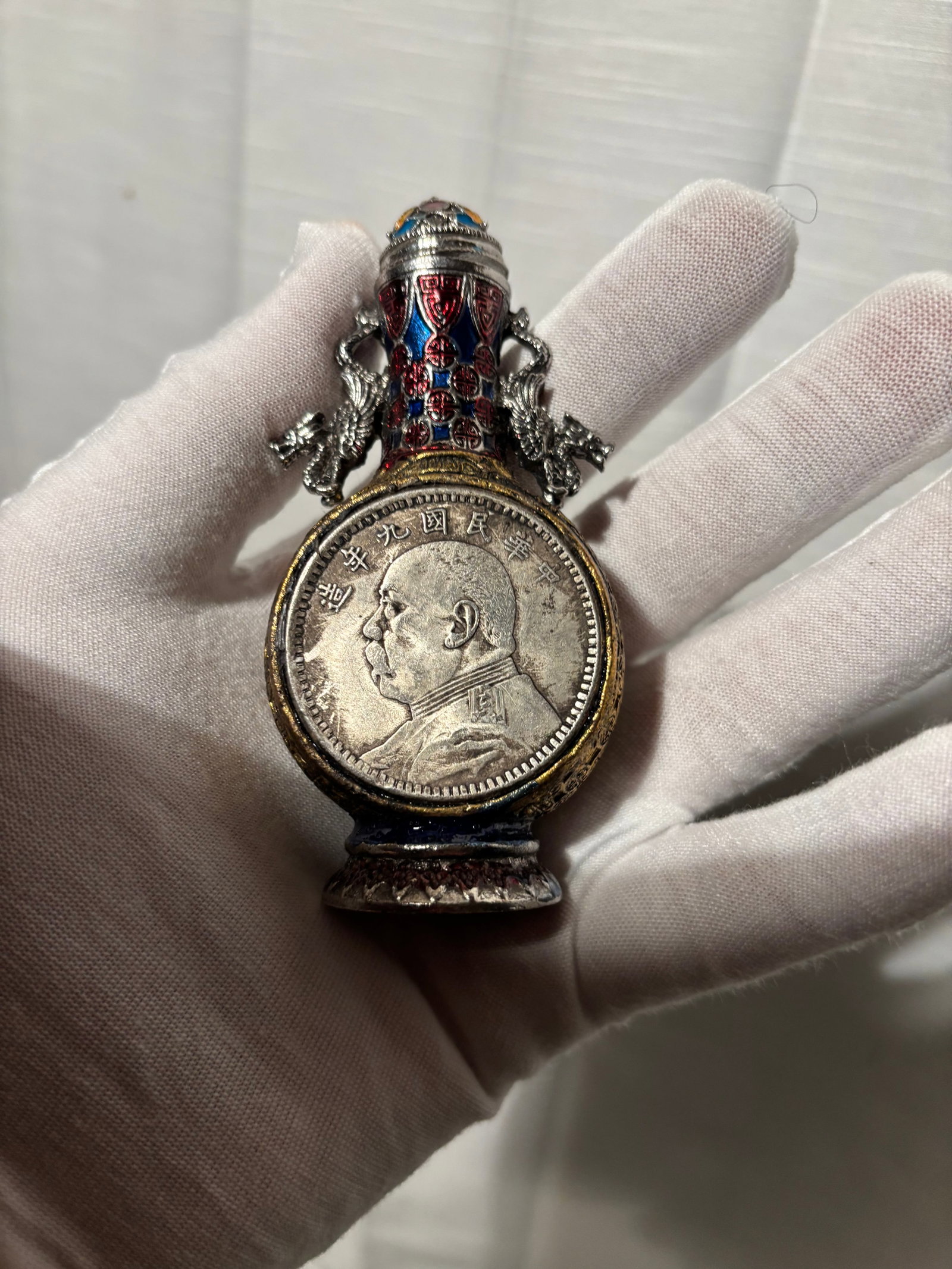 A Chinese Cloisonné Enamel Dragon Vessel Mounted Yuan Shikai “Fat Man?? Dollar (Snuff Bottle: A Chinese cloisonné enamel decorated vessel in the form of a snuff bottle, featuring elaborate dragon-form side handles and vibrant polychrome enamel panels. The piece is mounted with a Yuan Shikai �