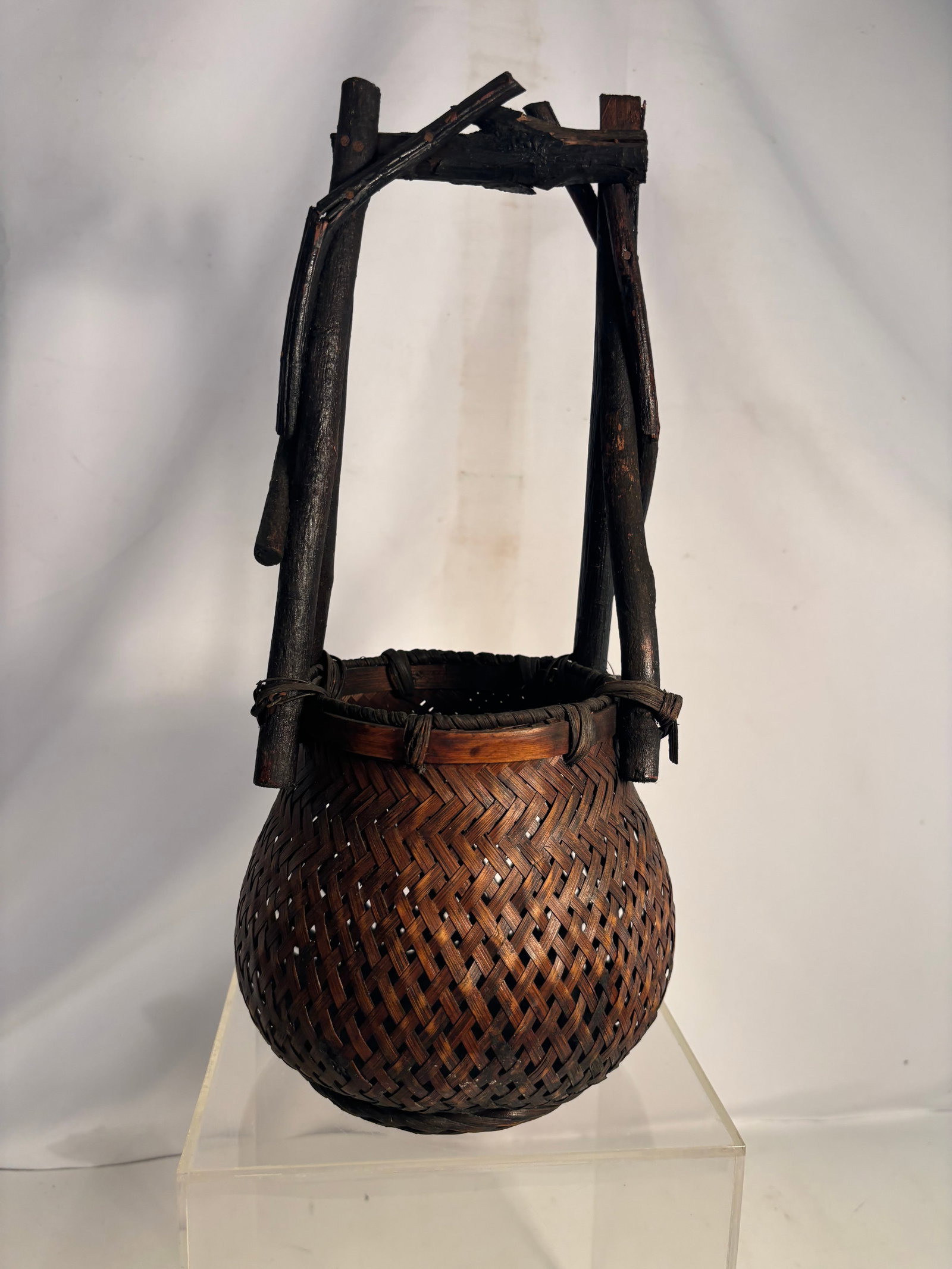 Japanese Meiji Period Woven Bamboo Ikebana Flower Basket: An antique Japanese hanakago flower-arranging basket dating to the Meiji period (1868–1912). The rounded body features open lattice and herringbone bamboo weaving, a reinforced rim, and a tall rusti