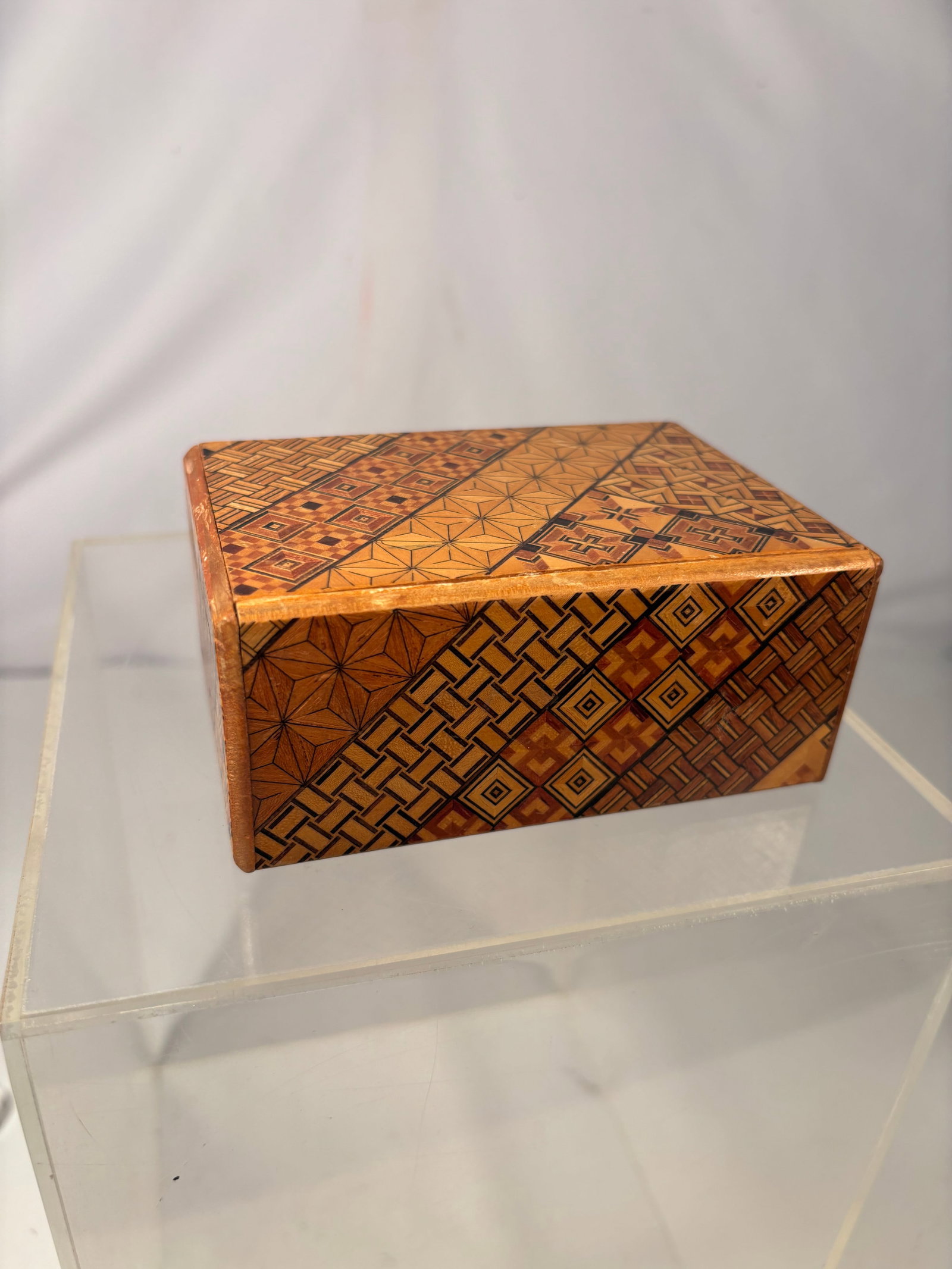 Japanese Hakone Yosegi Zaiku Marquetry Puzzle Box: A vintage Japanese yosegi-zaiku wooden puzzle or secret box, likely made in the Hakone region. The rectangular box is decorated on all sides with intricate geometric mosaic patterns created from contr