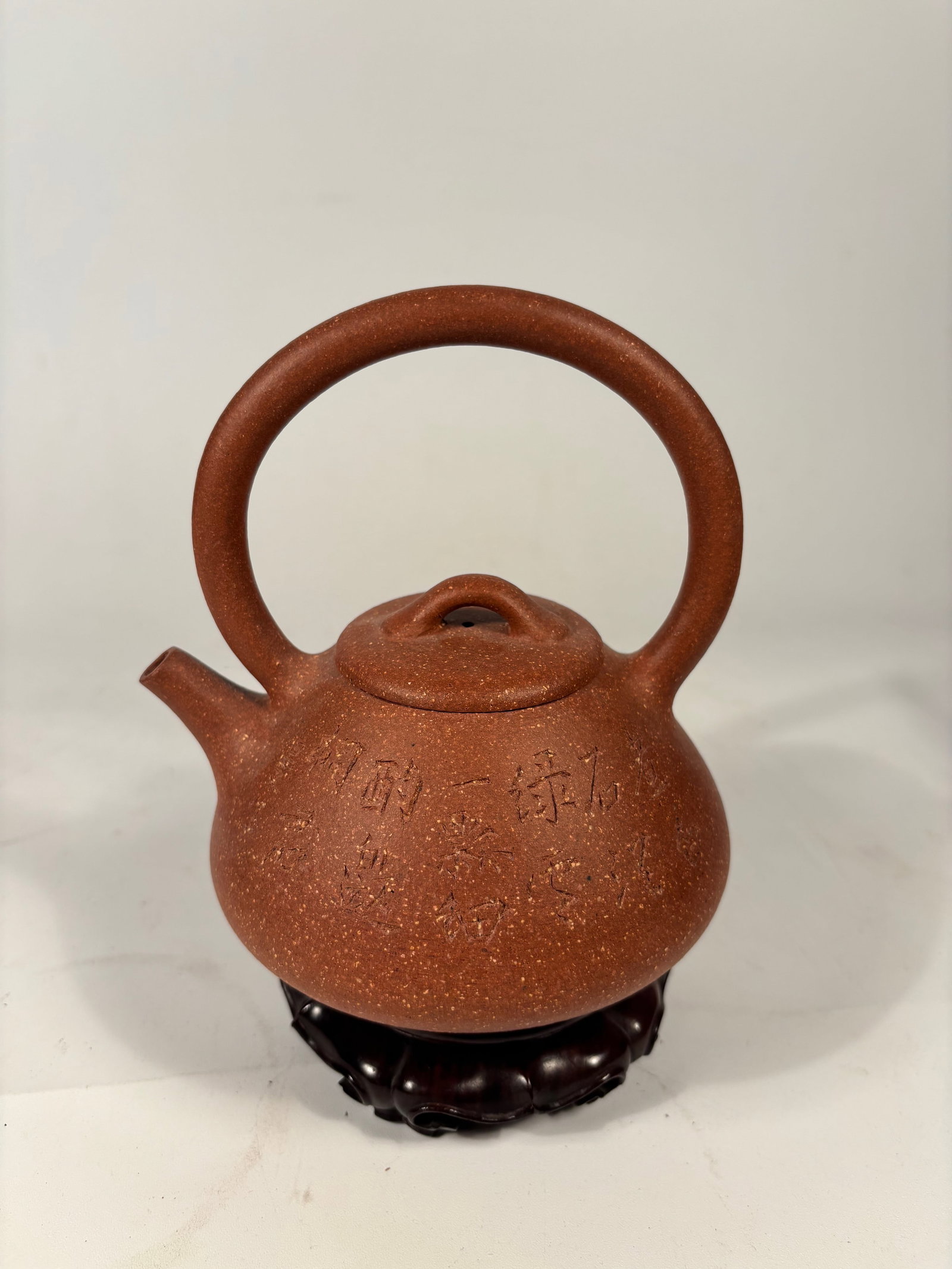 A Chinese Yixing Zisha Teapot with Calligraphy “Mansheng" and Stamped "Peng Nian": LATE 19TH TO EARLY 20TH CENTURY; A finely crafted Chinese Yixing Zisha teapot, made in the manner of the celebrated Qing dynasty potter Yang Pengnian. The teapot is of compressed globular form with a 