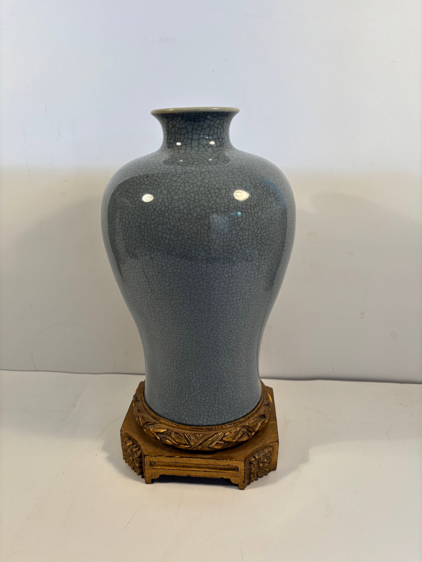 A Chinese sky blue Ge type porcelain Meiping vase: Qing Dynasty (1644-1912);The lighter blue tone, combined with the even crackling, looks very refined ; The gilded wooden stand also hints that was valued as a important piece. Dimensions?Vase Height: 
