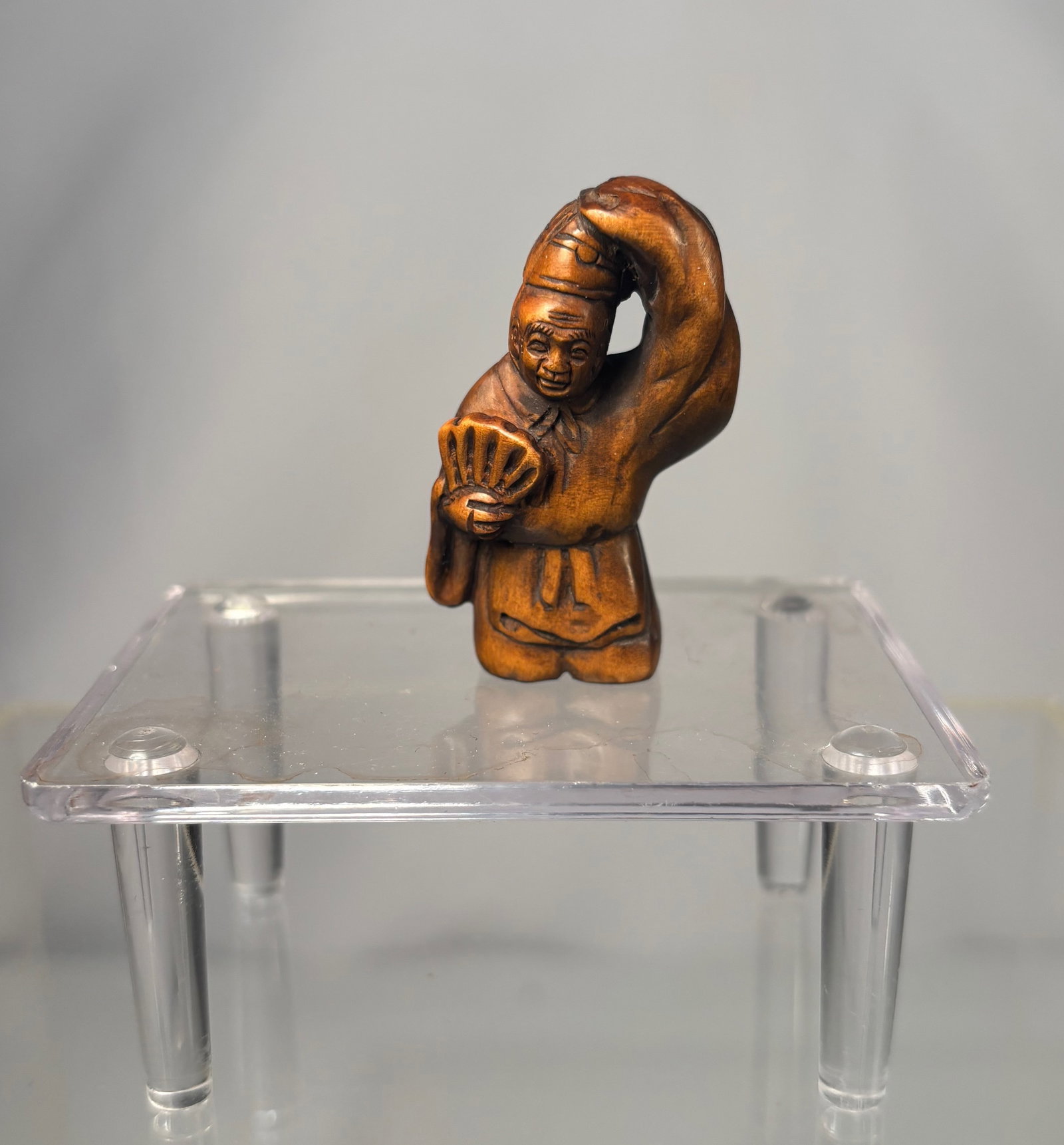 A Japanese Boxwood Netsuke of a Karako Holding a Fan, Signed (Gyokumatsu)
