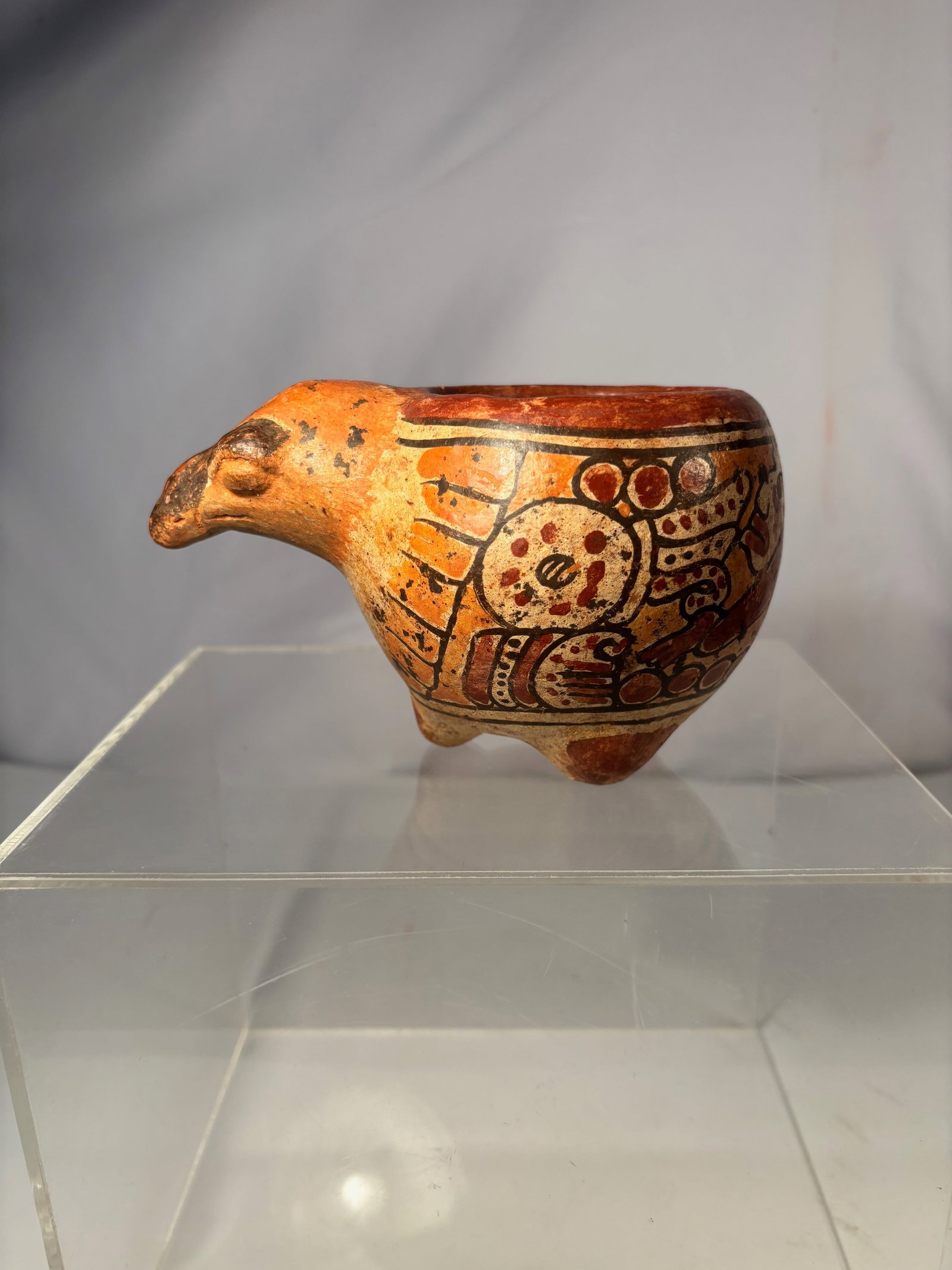 A Pre-Columbian Style Terracotta Bird-Form Tripod Vessel, Possibly West Mexico (Colima Tradition): Pre-Columbian style terracotta bird-form vessel, likely inspired by West Mexican (Colima tradition) shaft tomb ceramics. The hollow-bodied figure is modeled as a stylized bird with a projecting beak-f