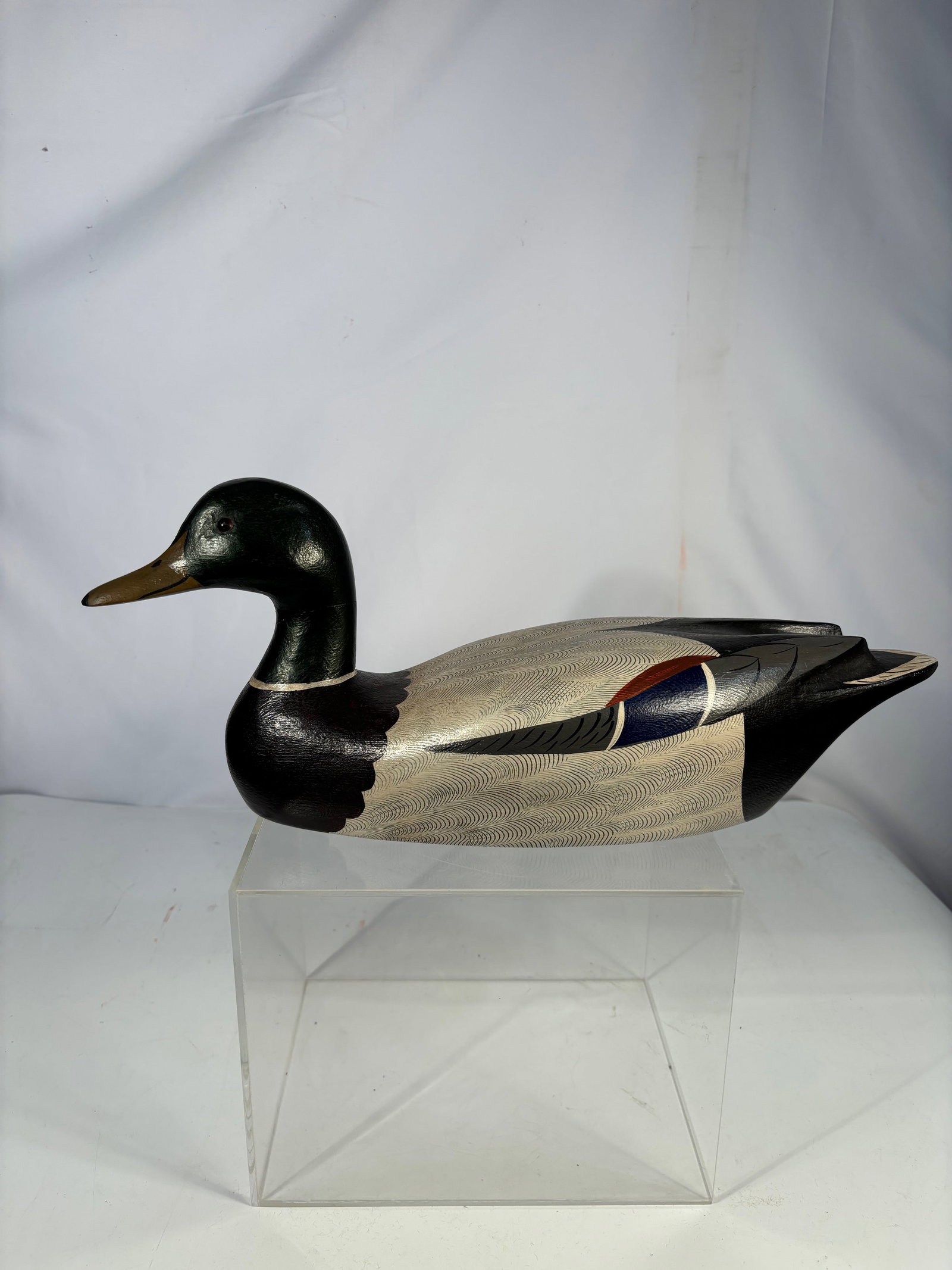Charles Moore Signed 1980 Carved Wooden Mallard Decoy: Hand-carved and hand-painted wooden mallard decoy signed and dated “Chas. Moore ’80” to the underside. Finely detailed feather carving with painted plumage in naturalistic tones. Length: 17 
