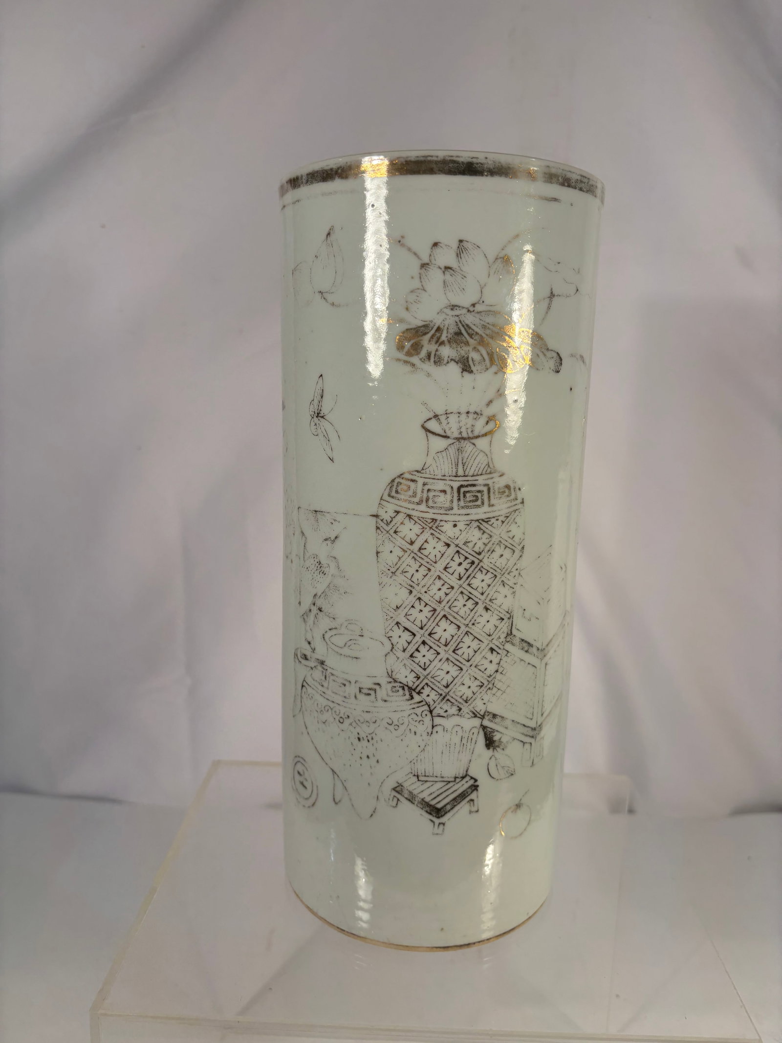 A Chinese Porcelain Hat Stand with Scholar’s Objects Motif: Qing dynasty(1644-1912) ,A Chinese porcelain hat stand, late Qing to Republic period, of tapering cylindrical form. The body is finely decorated in monochrome grisaille-style enamels with a refined sc