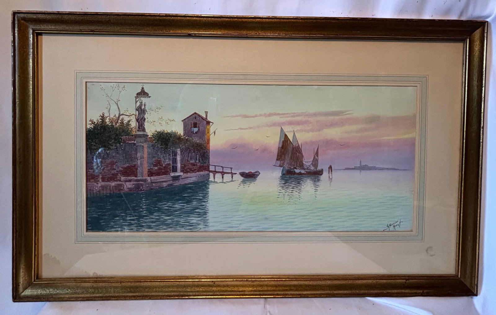 G. Buccini (Italian, 20th Century), “Venetian Garden?? Watercolor: Original watercolor on paper depicting a serene Venetian waterfront with sailing boats, garden walls, and distant architecture under a softly illuminated sky. Executed in delicate pastel tones with su