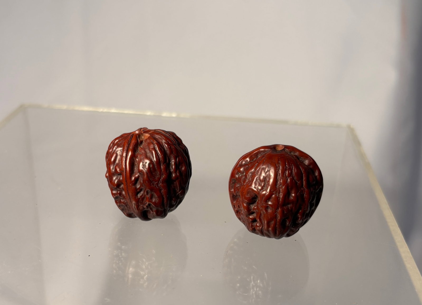 Two Chinese Carved Olive Pit Walnut Form Pendants
