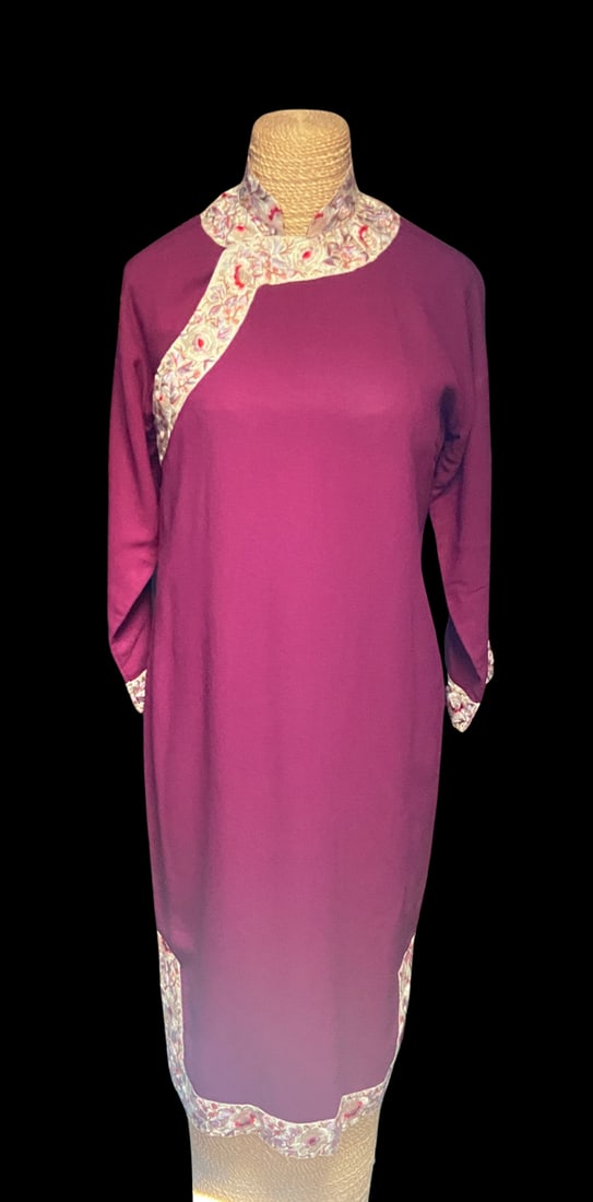 Vintage Chinese Wool Cheongsam Qipao by Nanjing Yong An Co. Provenance, Embroidered Trim: Vintage Chinese wool cheongsam (qipao) in a rich plum color, accented with embroidered silk brocade trim along the Mandarin collar, asymmetrical front closure, sleeve cuffs, and hem. The interior reta