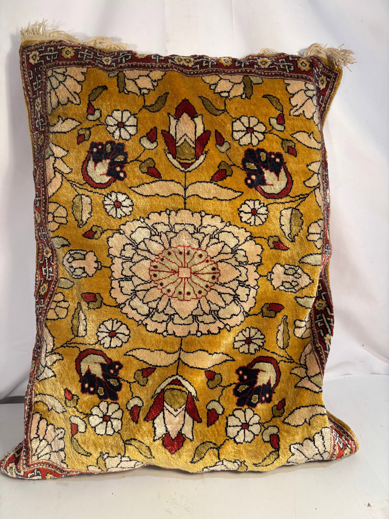 Vintage Persian Hand-Knotted Silk Rug Pillow with Floral Medallion: A vintage Persian decorative pillow featuring a hand-knotted silk rug face centered by a large floral medallion surrounded by stylized blossoms, buds, and leafy vines against a rich golden-yellow fiel
