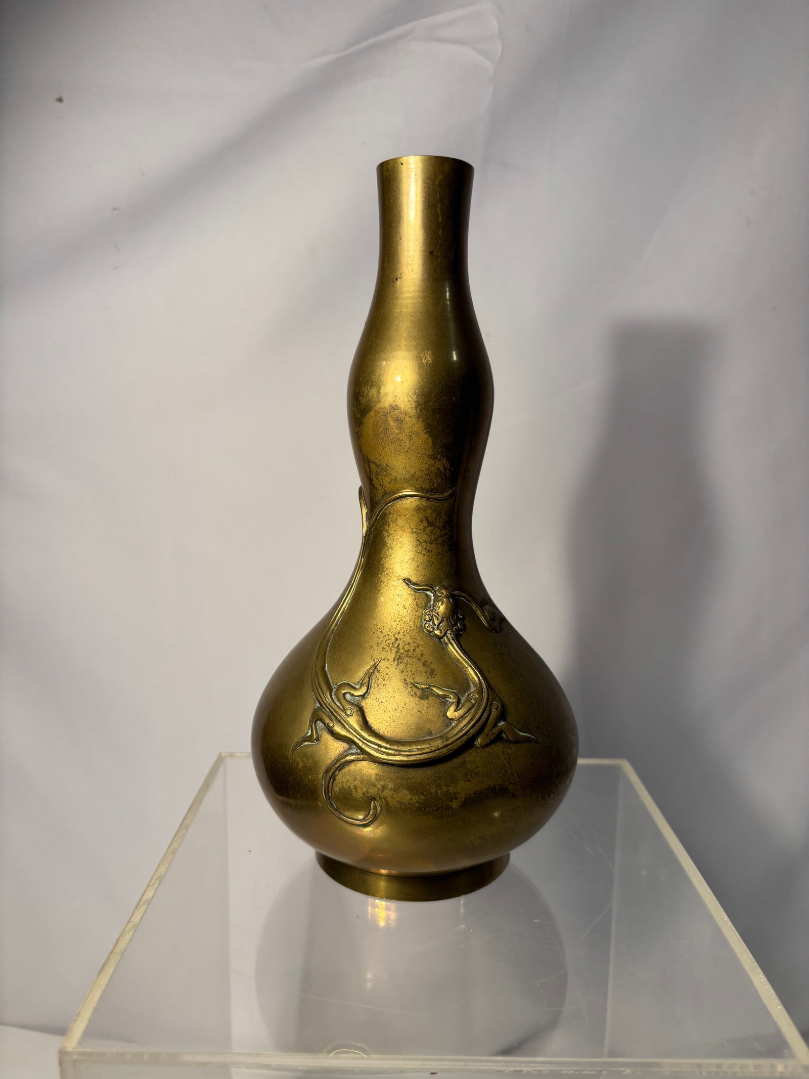 A Japanese Bronze Gourd-Form Vase with Dragon Relief, Meiji Period Style: Meiji period style, late 19th to early 20th century. Japanese bronze gourd-form vase featuring an applied dragon in relief winding around the body. The elongated dragon is rendered in a flowing, sinuo