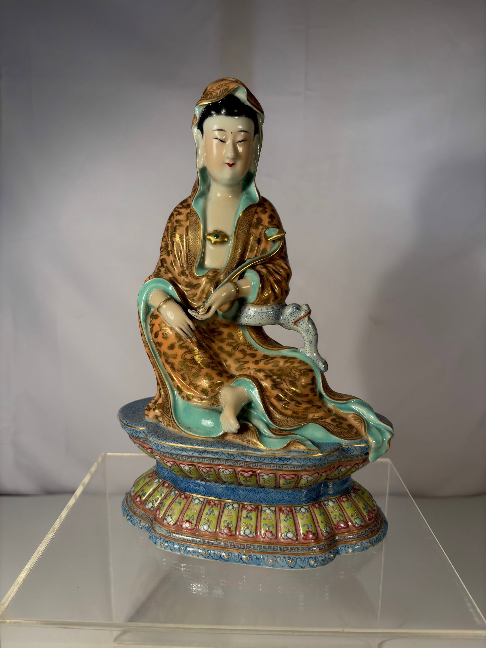 An enamelled Chinese famille rose porcelain figure of Guanyin marked "ZENG LONRSHENG": ZENG LONRSHENG (1901-1964); Zeng Longsheng (1901-1964) was a celebrated potter at the Jingdezhen kilns who specialised in figural sculptures.His piece could be found can be found in the collection of 
