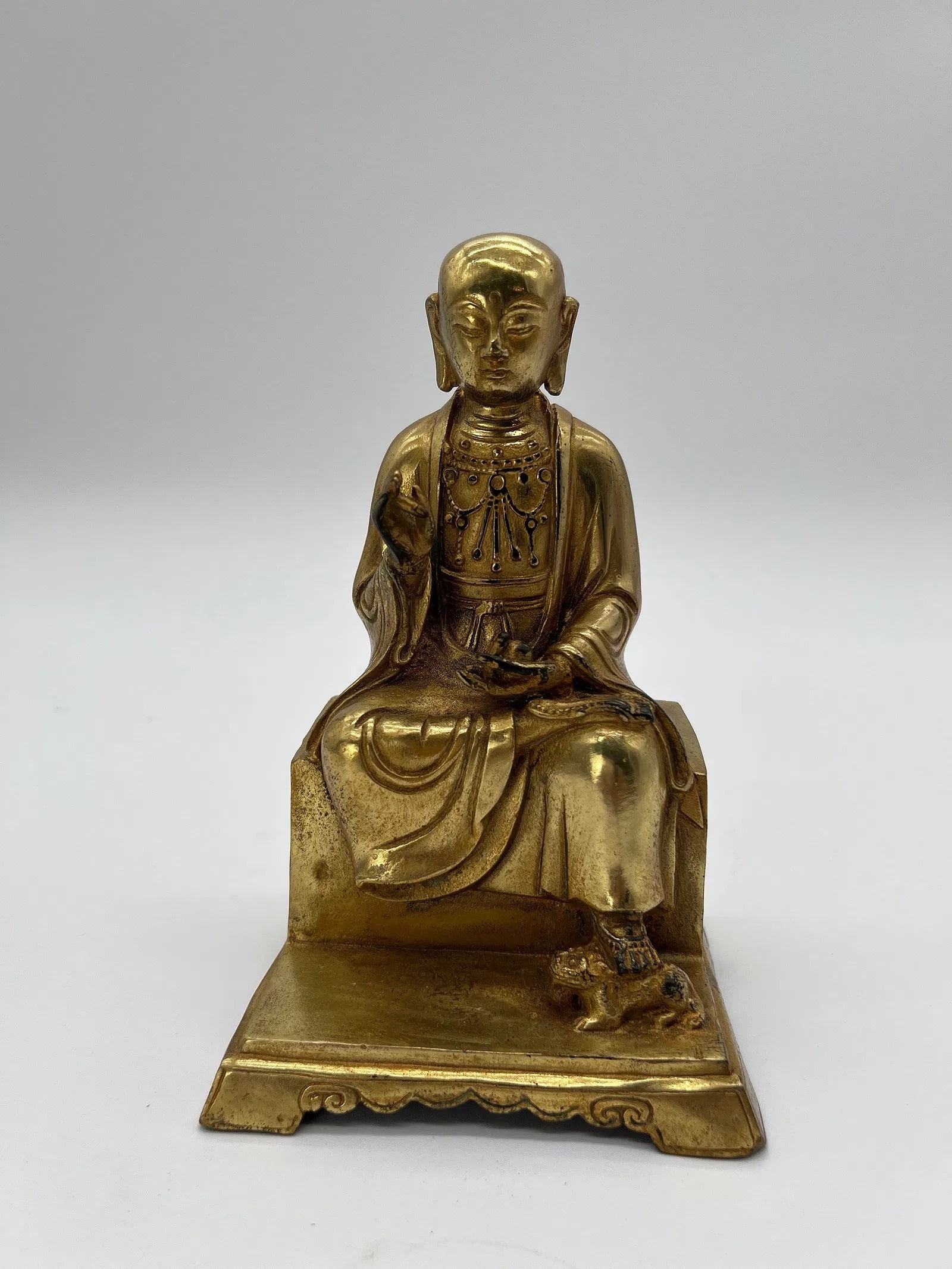 A Chinese gilt bronze figure of a seated monk: Antique Chinese gilt bronze figure of seated monk , probably 19th century. Dimensions?Height: 7 inches